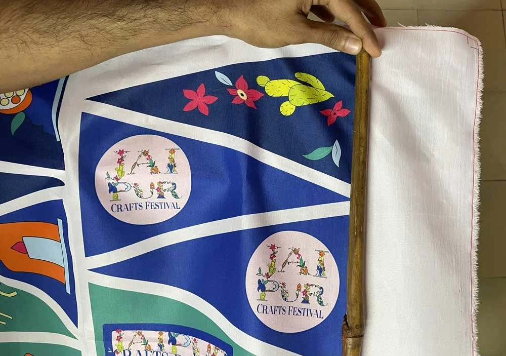Colorful fabric with 'Jaipur Crafts Festival' logo and floral designs