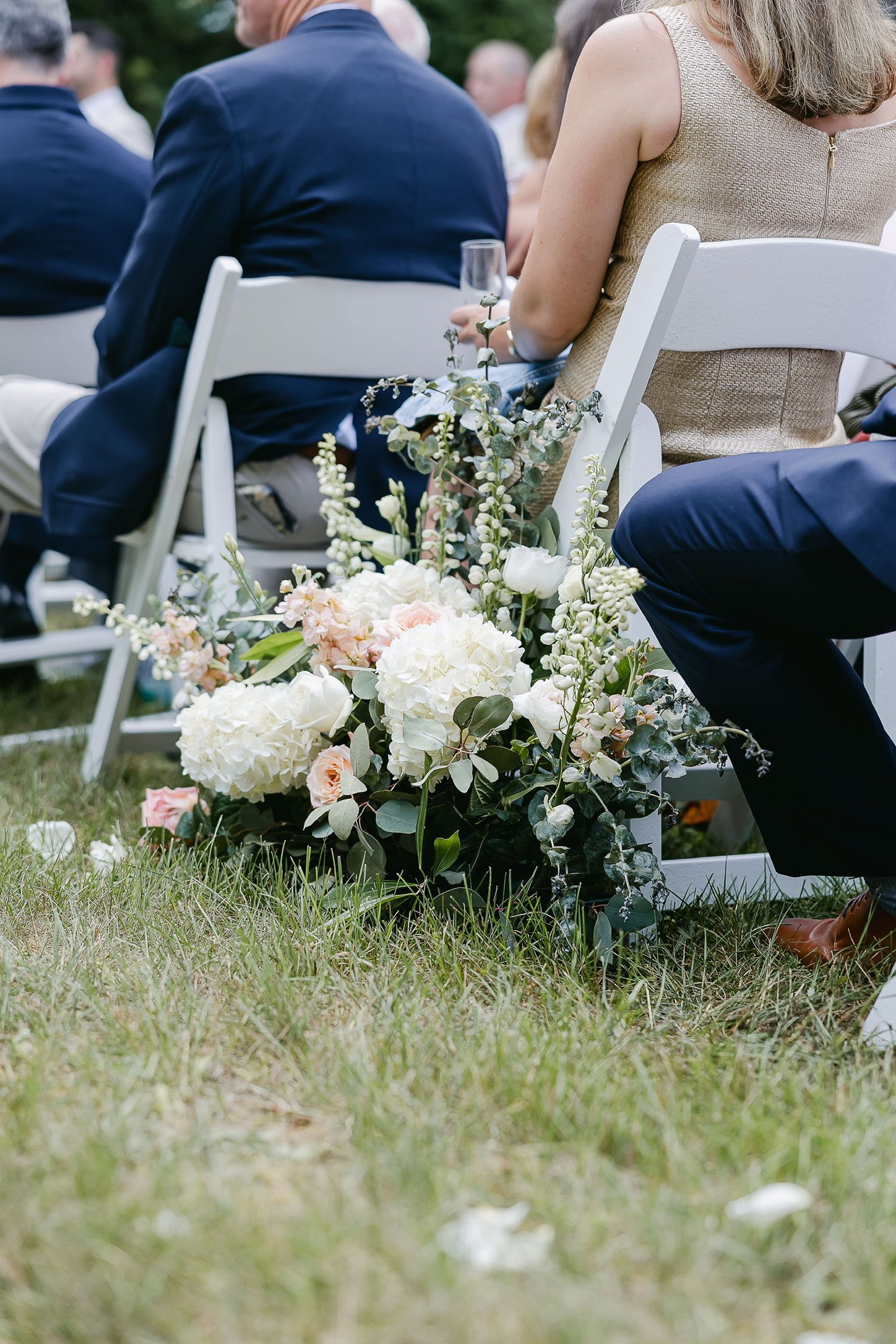 Outdoor wedding seating with floral arrangement