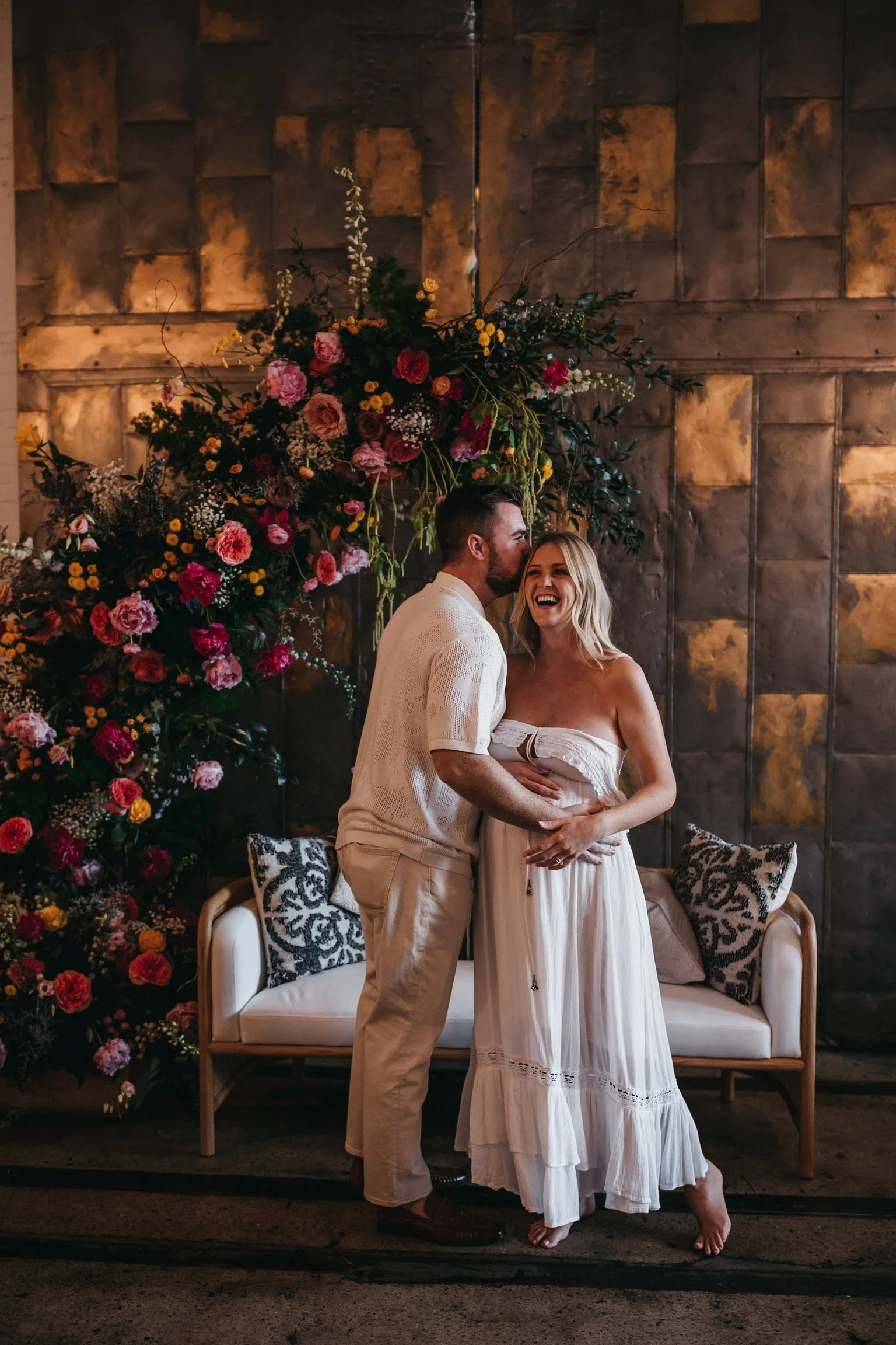 Smiling couple with flower backdrop