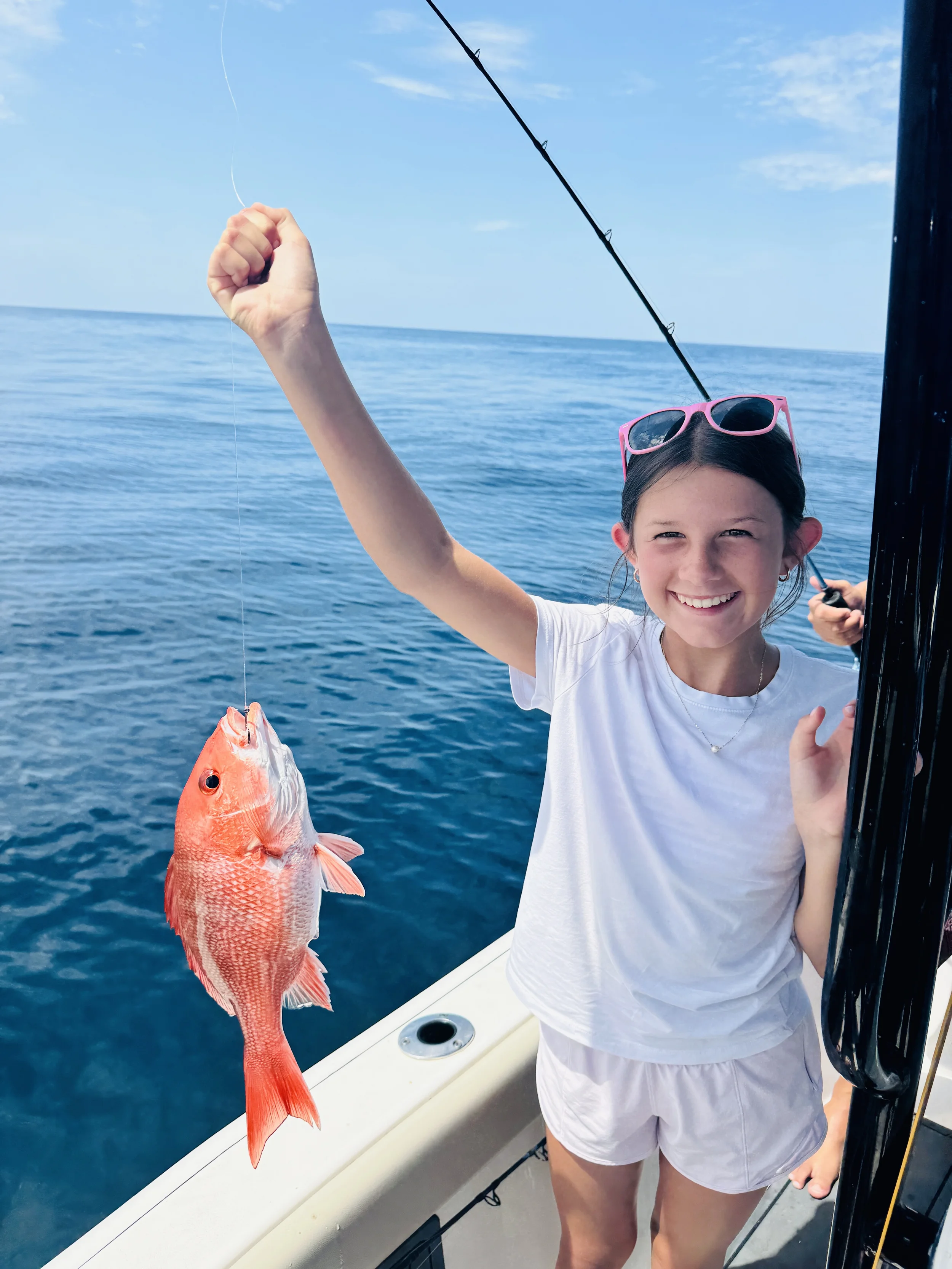 Happy angler showing off a vermilion snapper during a Bluewater Charter offshore fishing trip