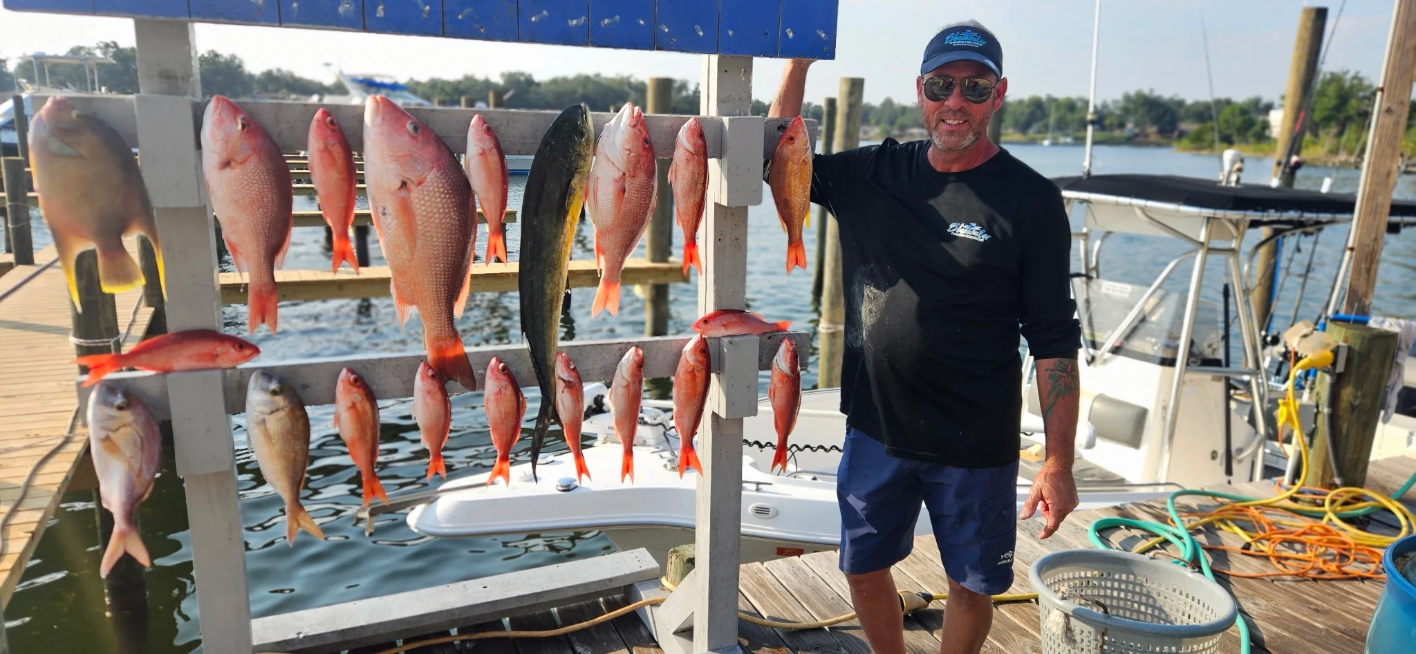 Captain Steve standing on a dock with fish caught in the Gulf
