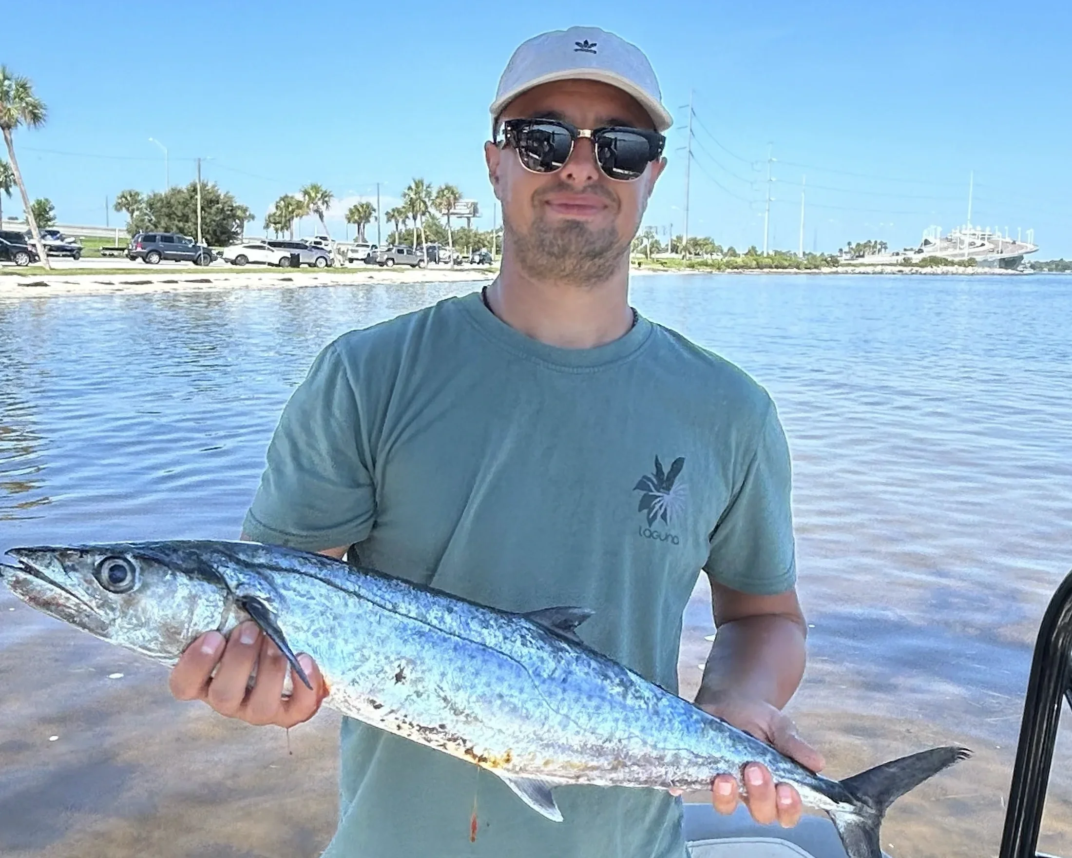 A man holds up a king mackerel he caught offshore with Bluewater Charter in the Gulf