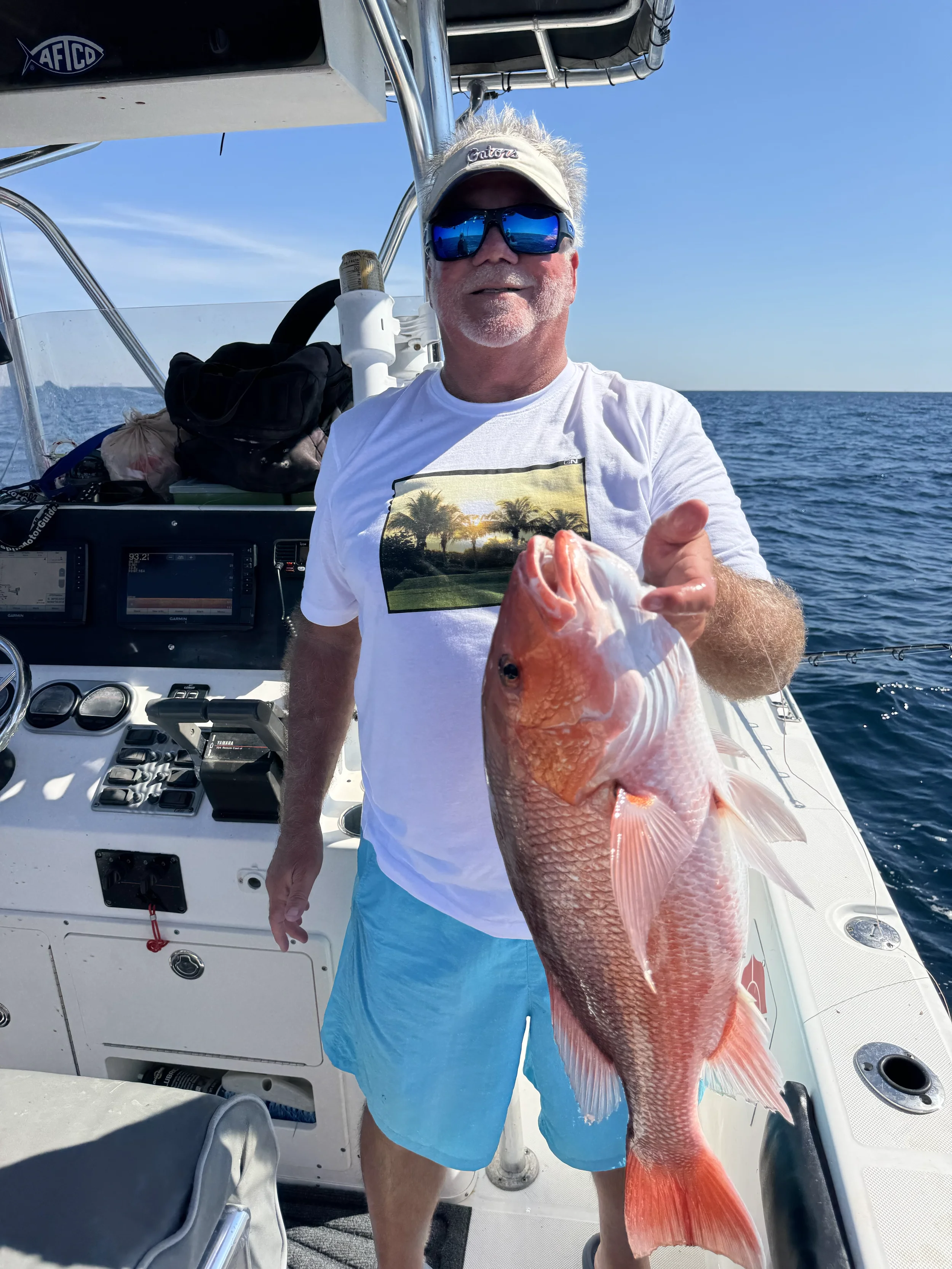 Man with his Red Snapper on a boat in the Gulf
