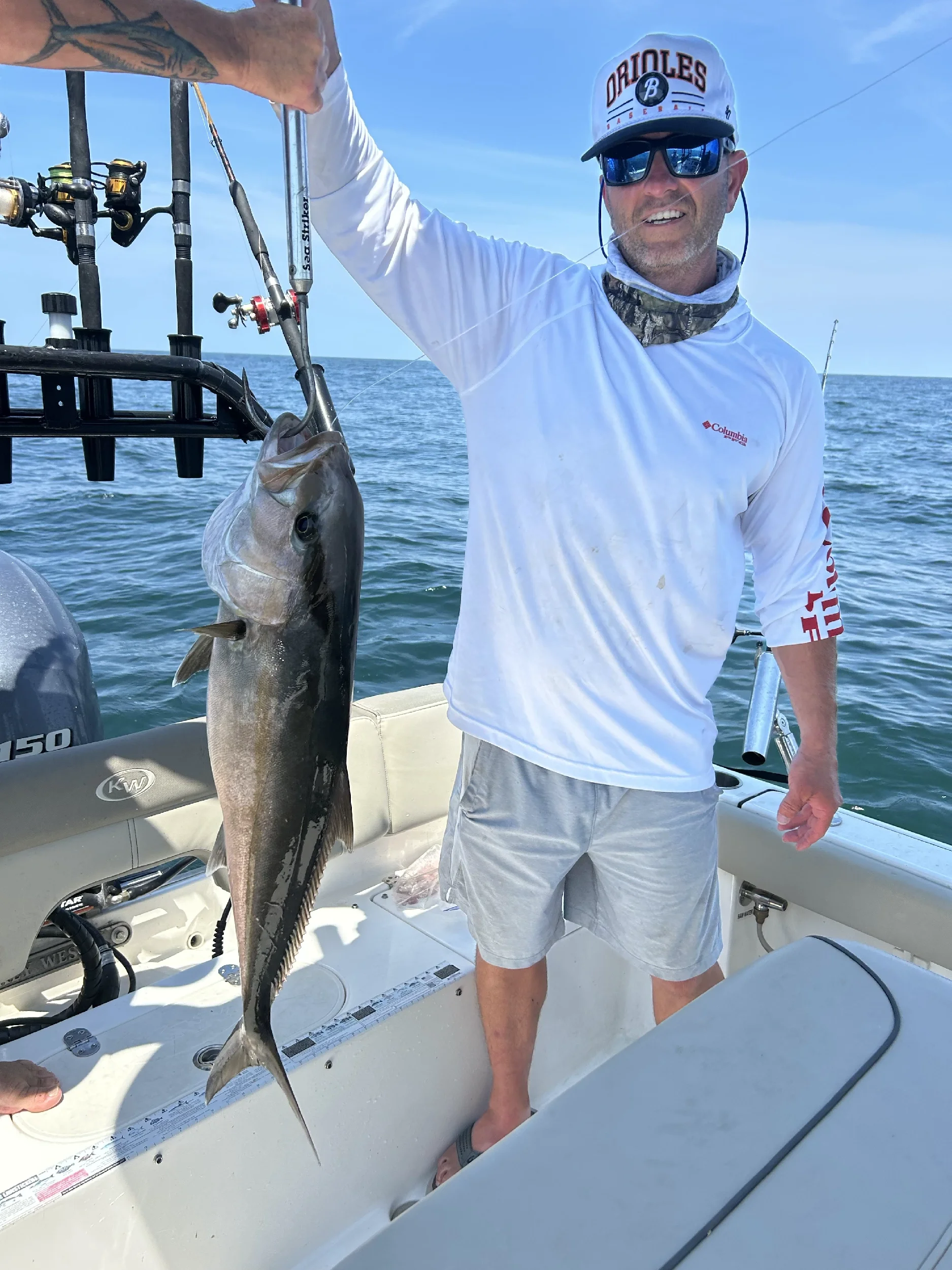 Man holding up his fish on a boat in the Gulf