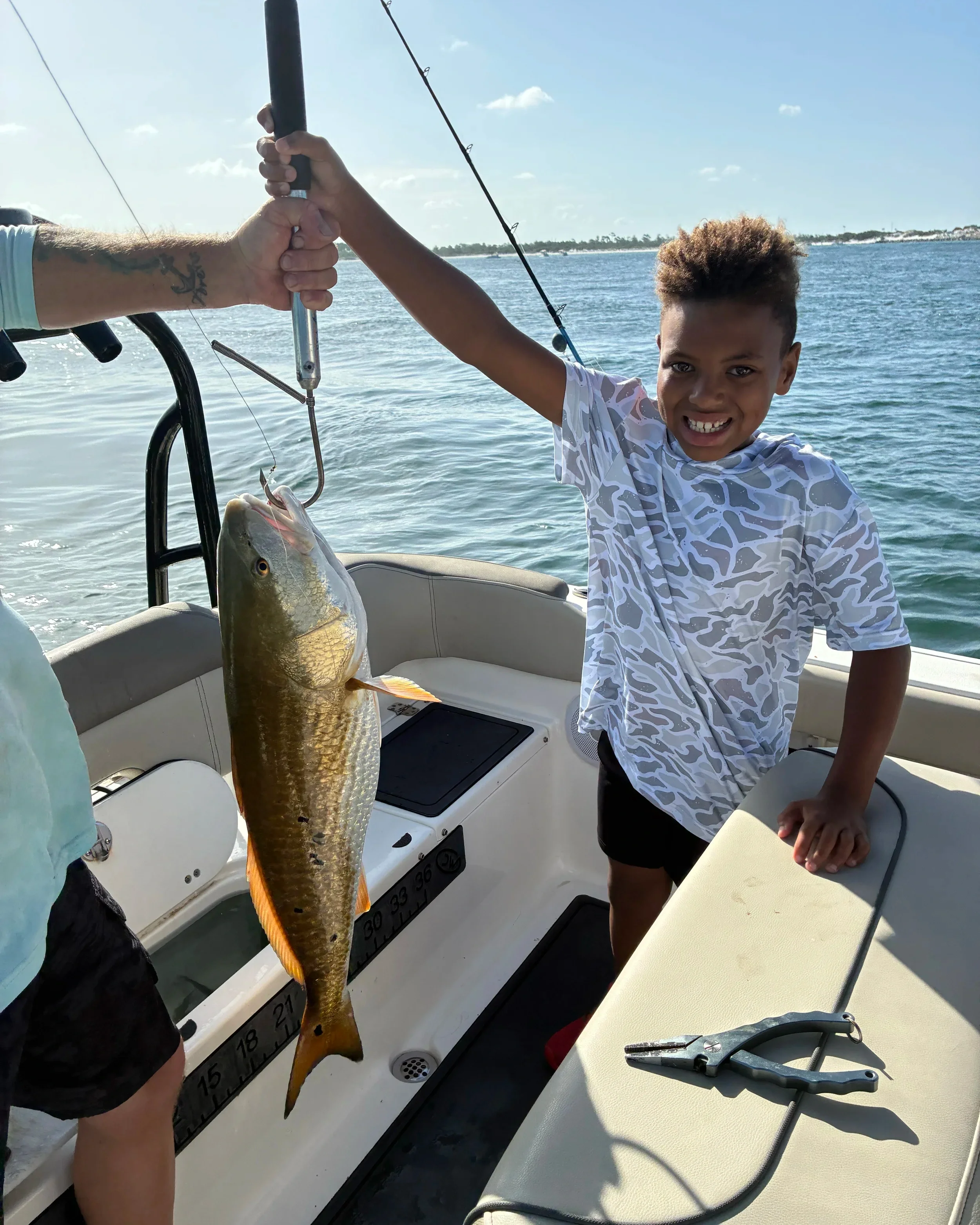 Happy angler showing off a redfish during a Bluewater Charter offshore fishing trip