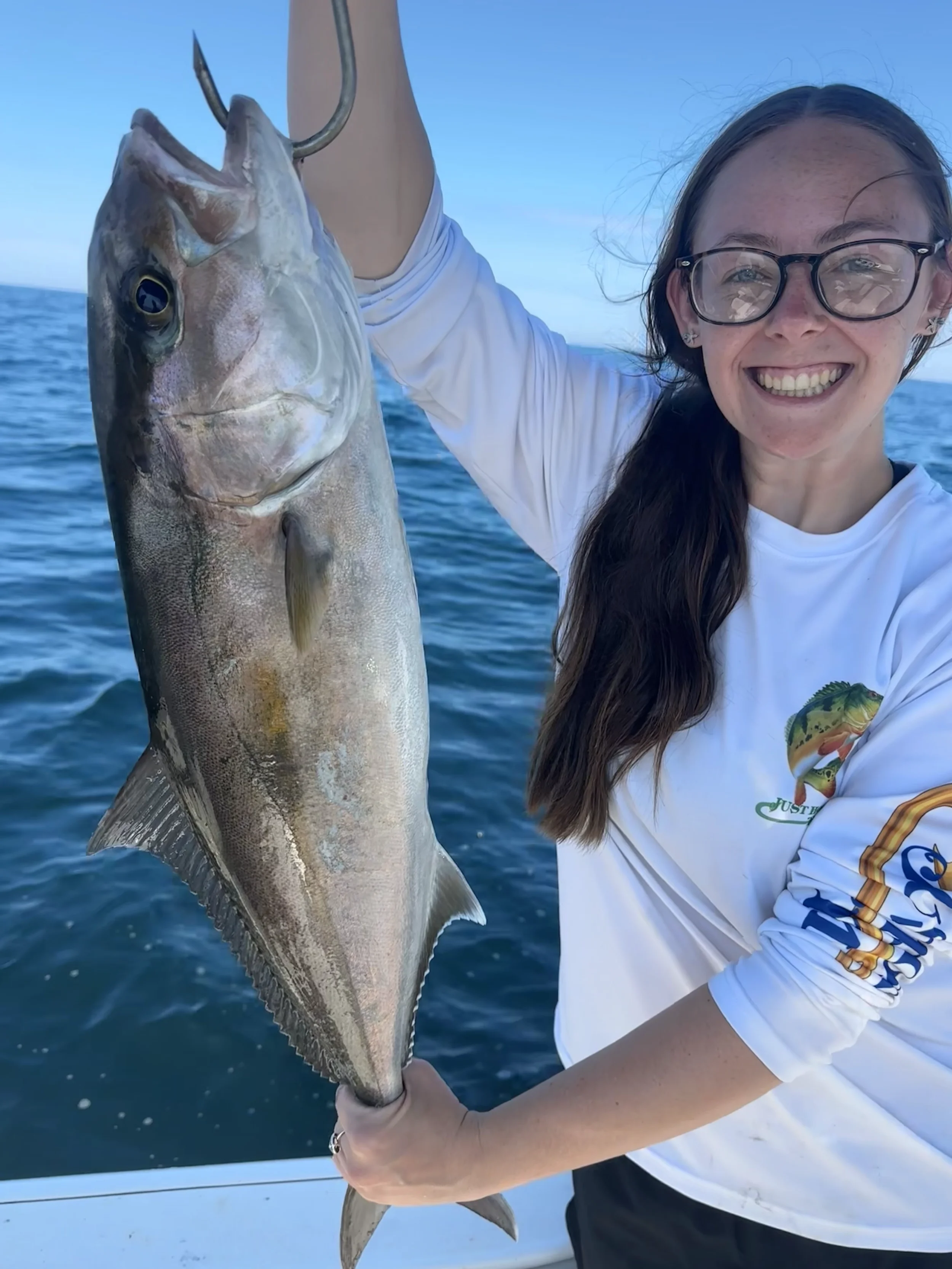 Woman holding up her fish she caught in the Gulf