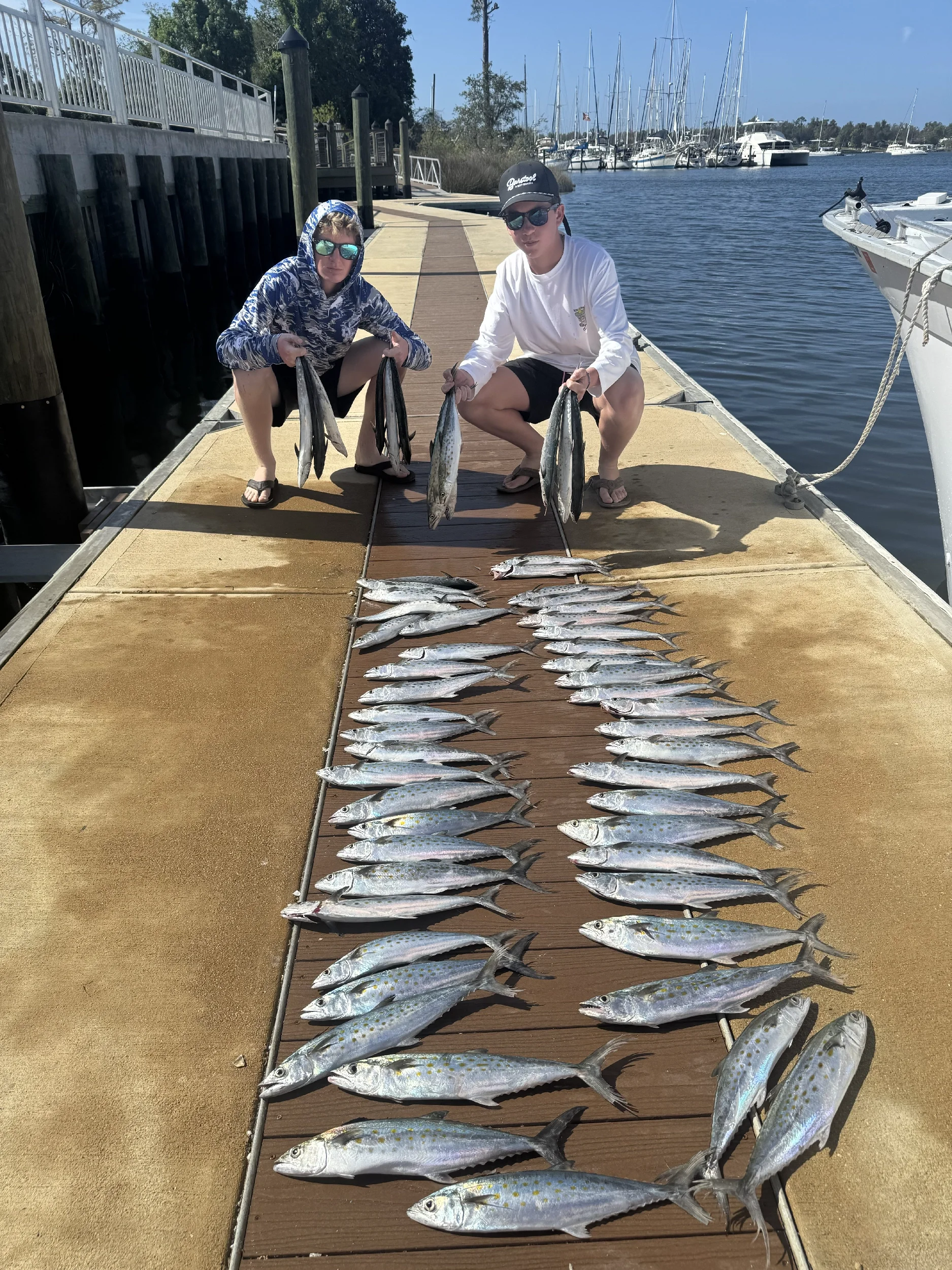 Teen boys on the dock with their Bluewater Charter caught Gulf fish