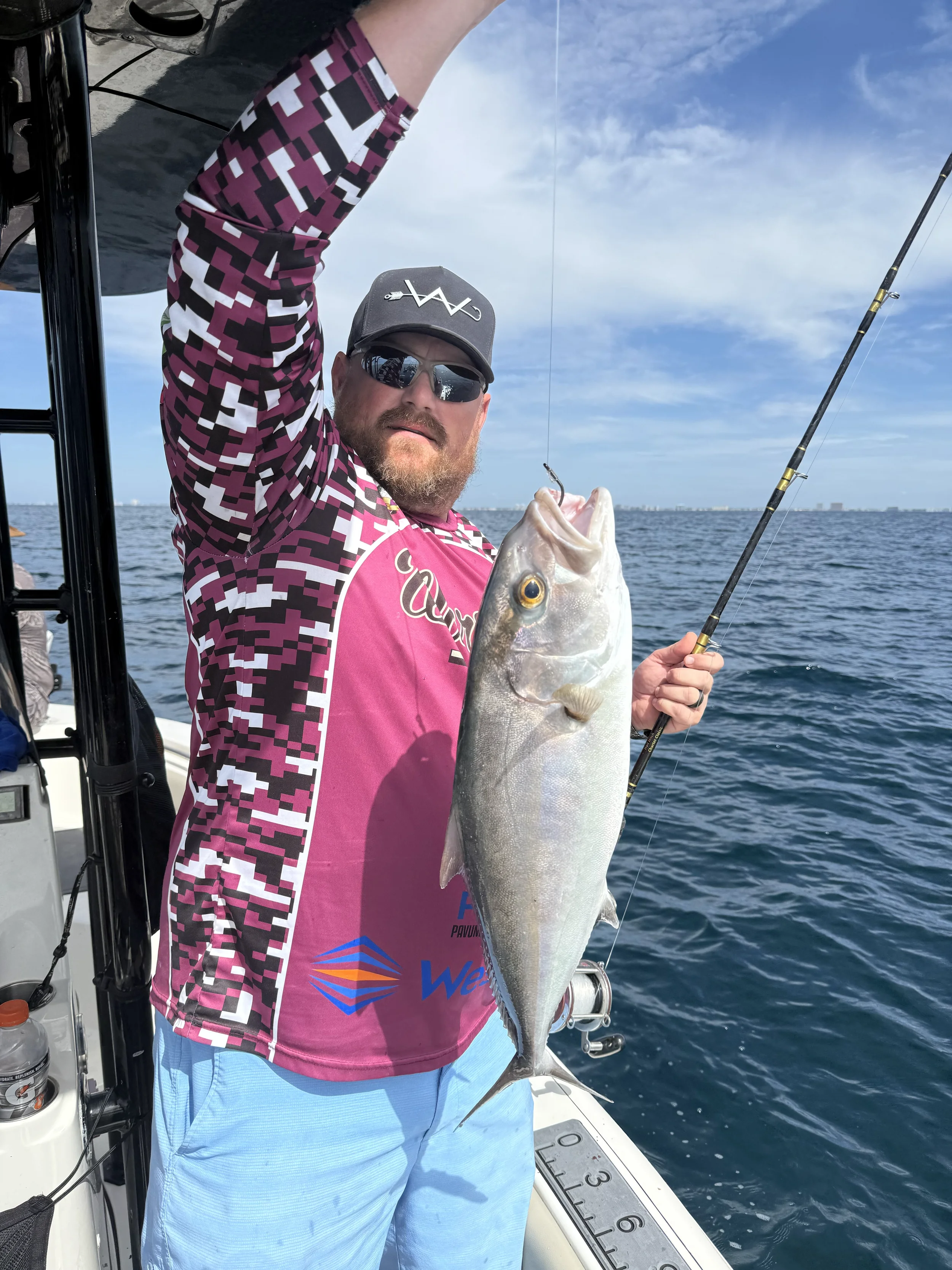 Man holding up a fish he caught in the Gulf