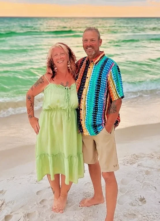 Captain Steve of Bluewater Charter and his lovely wife on the Gulf beach at sunset