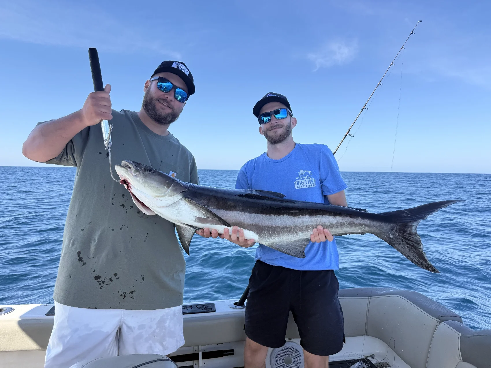 Two men hold up a Cobia they caught with Bluewater Charter in the Gulf