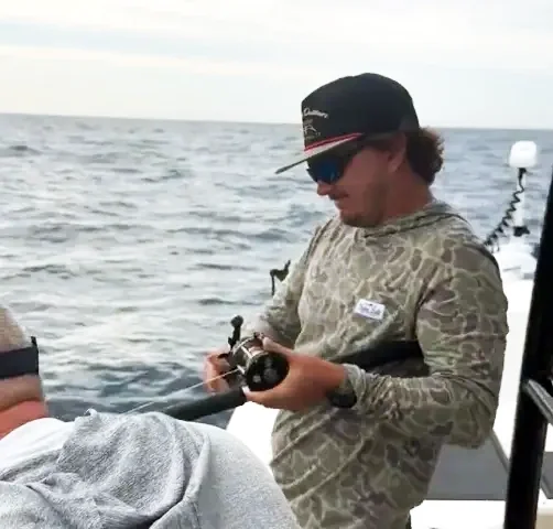 Man reeling in a fish in the Gulf of Florida