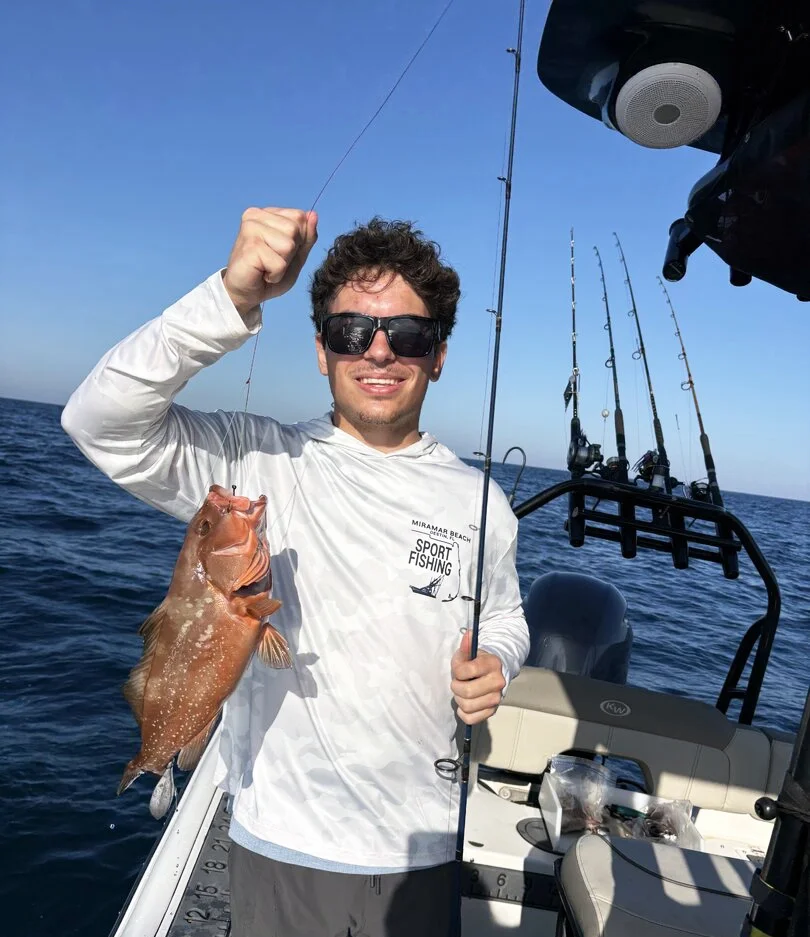 Happy guest sharing a memorable red grouper fishing experience with Bluewater Charter near 30A and Destin