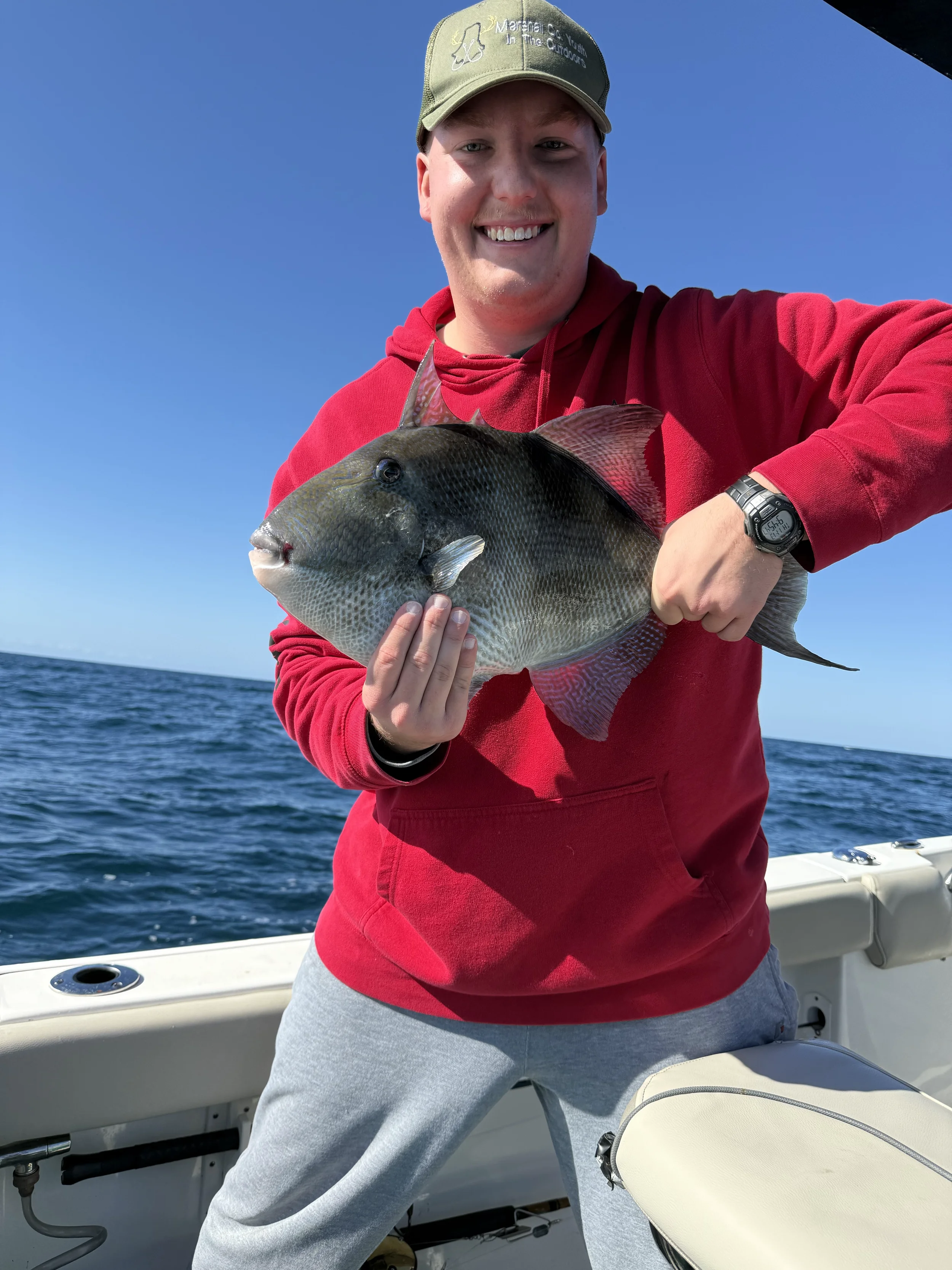 Man holding his Triggerfish catch in the Gulf