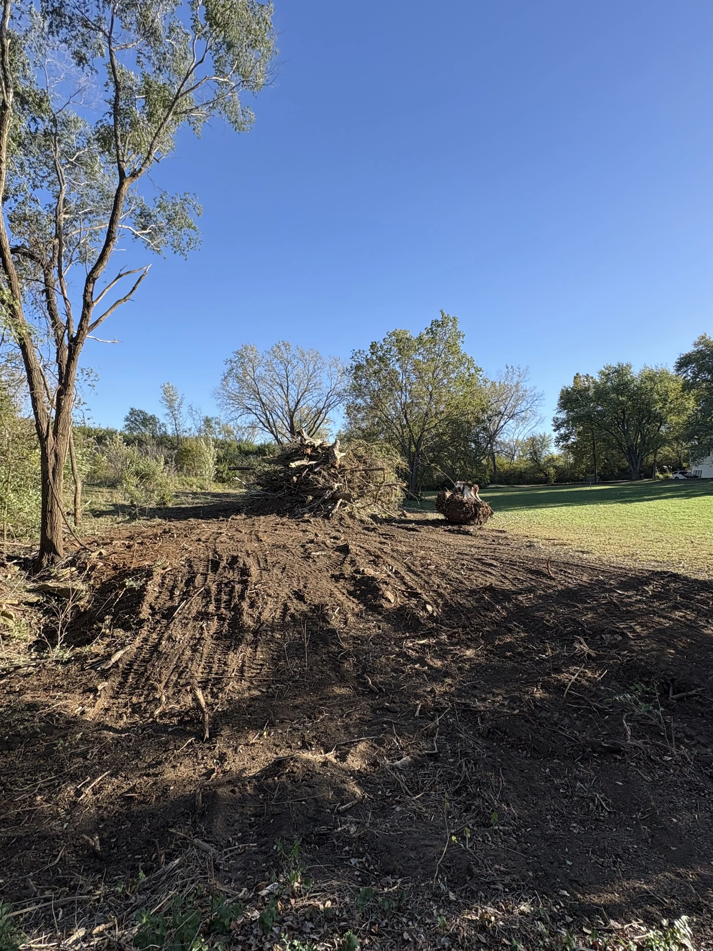 Initial land clearing and brush removal in Meriden, KS preparing site for grading.