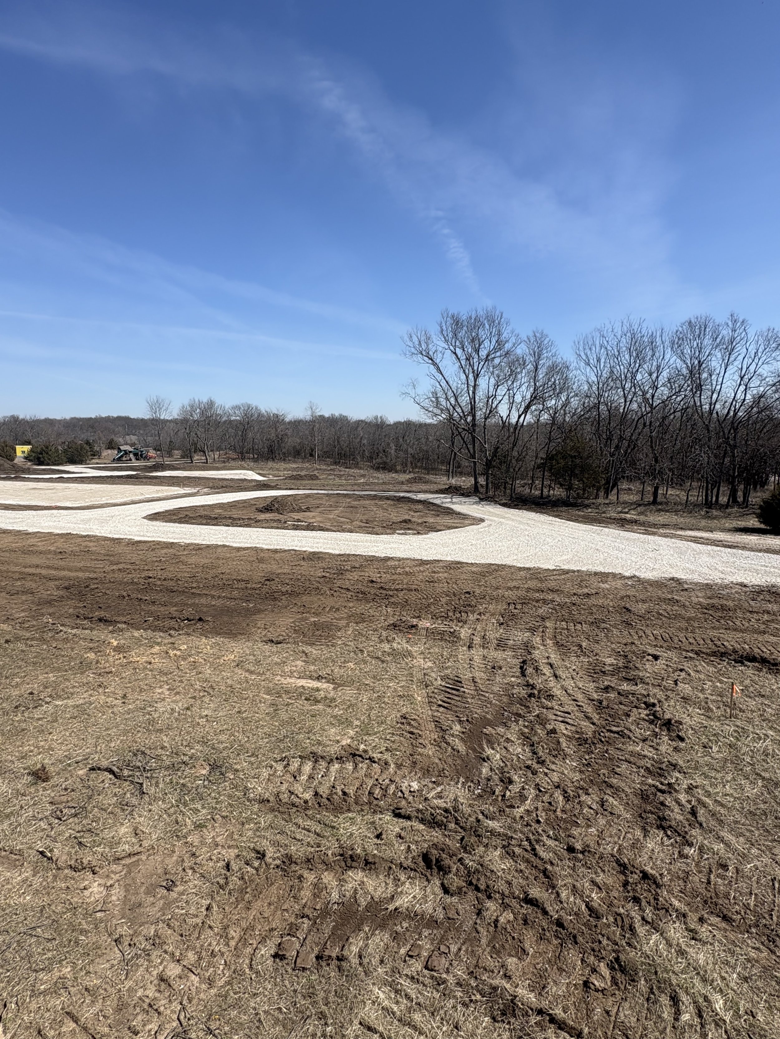 Land clearing and site preparation project completed in Louisburg, Kansas to prepare a rural property for future construction. Work included clearing trees and brush, grading the site, and preparing a stable building area for long-term use.