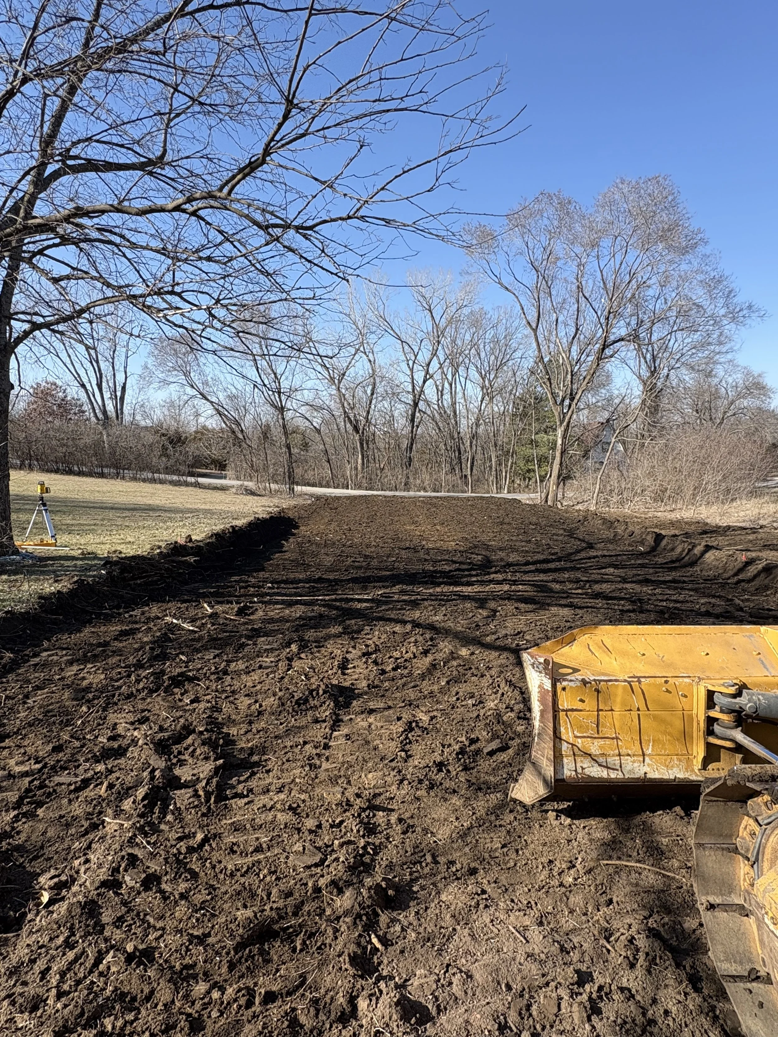 Final grading and site preparation using dozer to level building pad in Meriden, KS