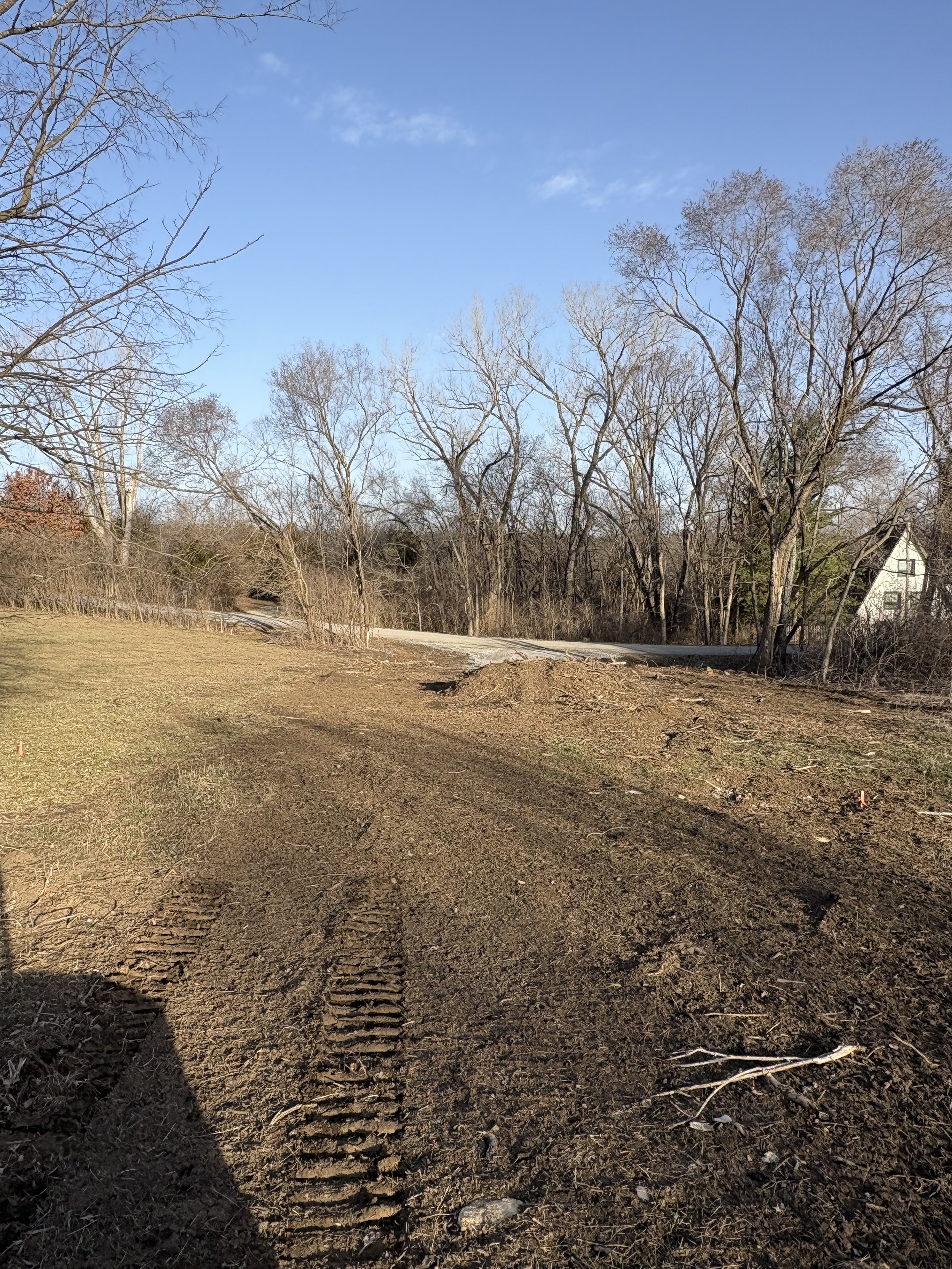 Rough grading and site preparation after land clearing in Meriden, KS.