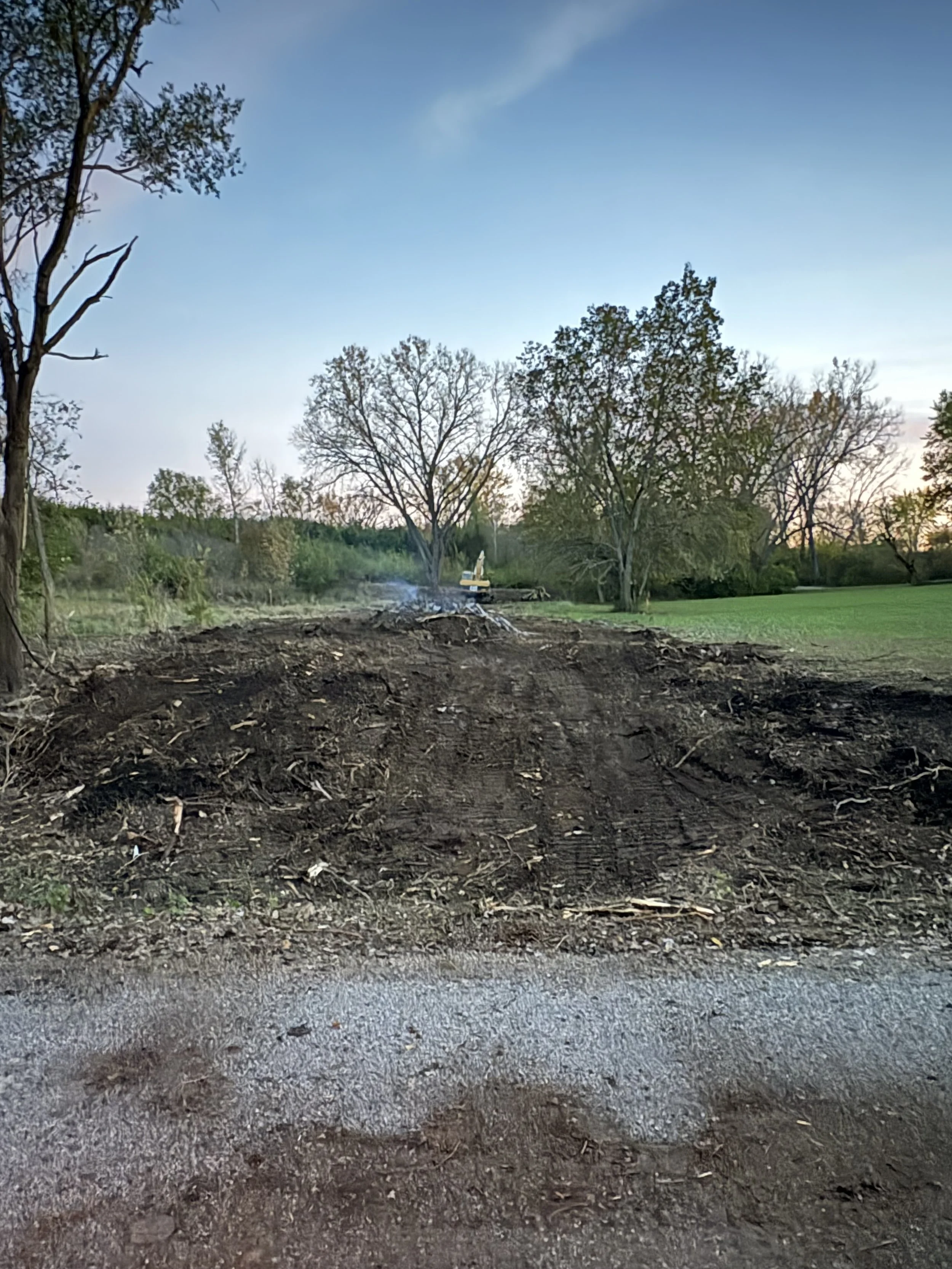 Cleared trees and debris piled during land clearing project in Meriden, Kansas.