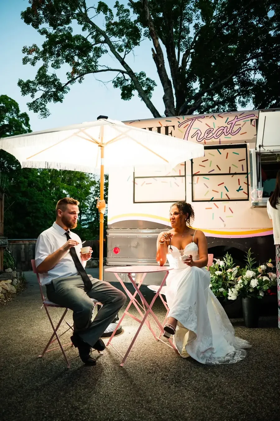 Newlyweds enjoying ice cream beside The Treat Trolley