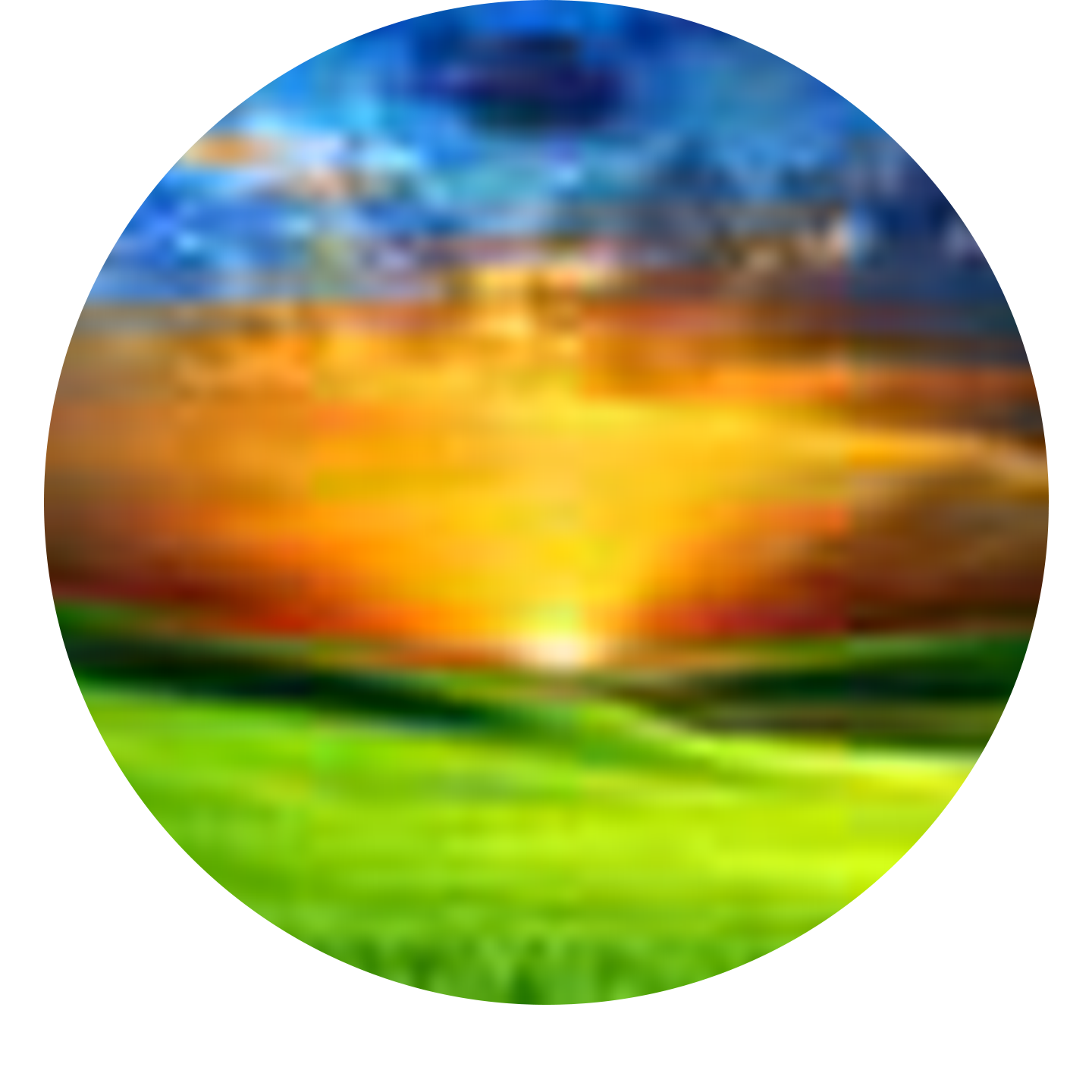 Abstract blurry image with blue sky, vibrant orange and yellow sunset reflection on water, and green grass at the bottom.