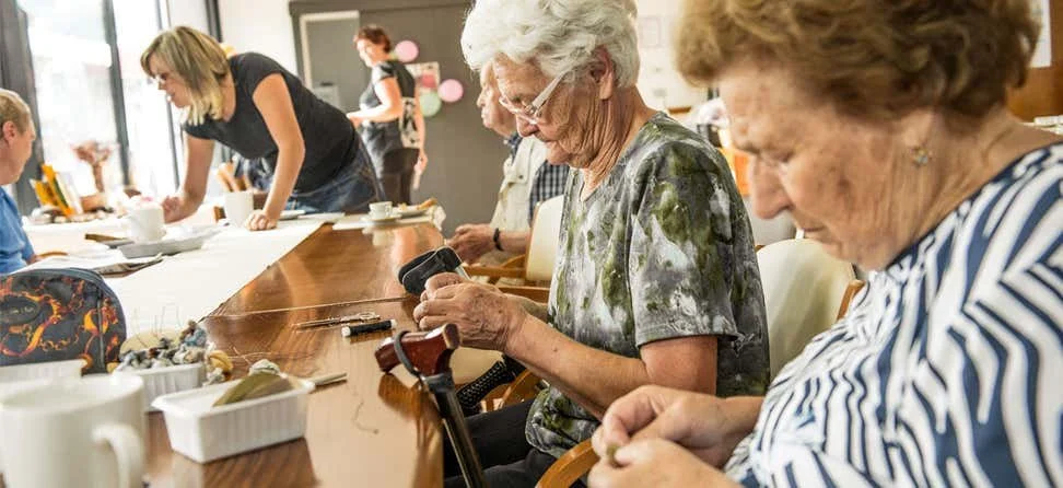 Seniors socializing and enjoying activities in a community-style senior living facility in Beaverton Oregon