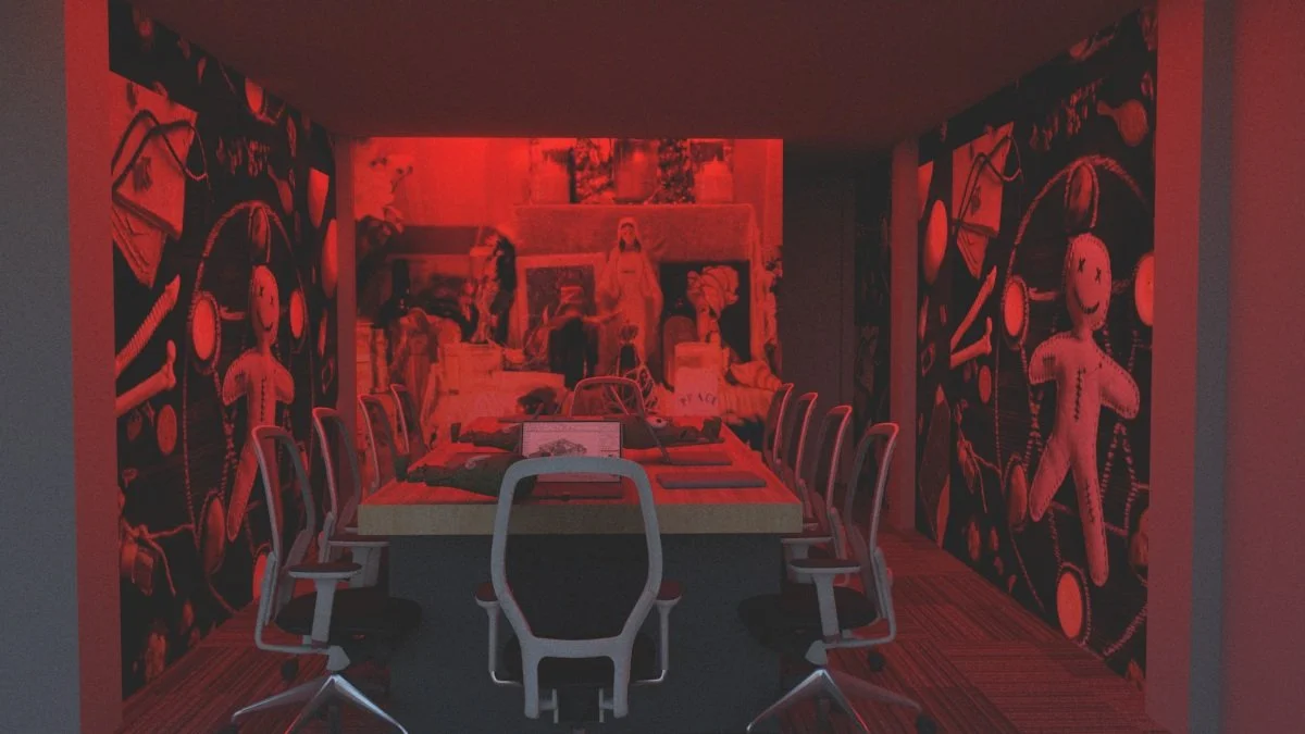 Red-lit conference room with artwork on walls, featuring seated chairs around a rectangular table.