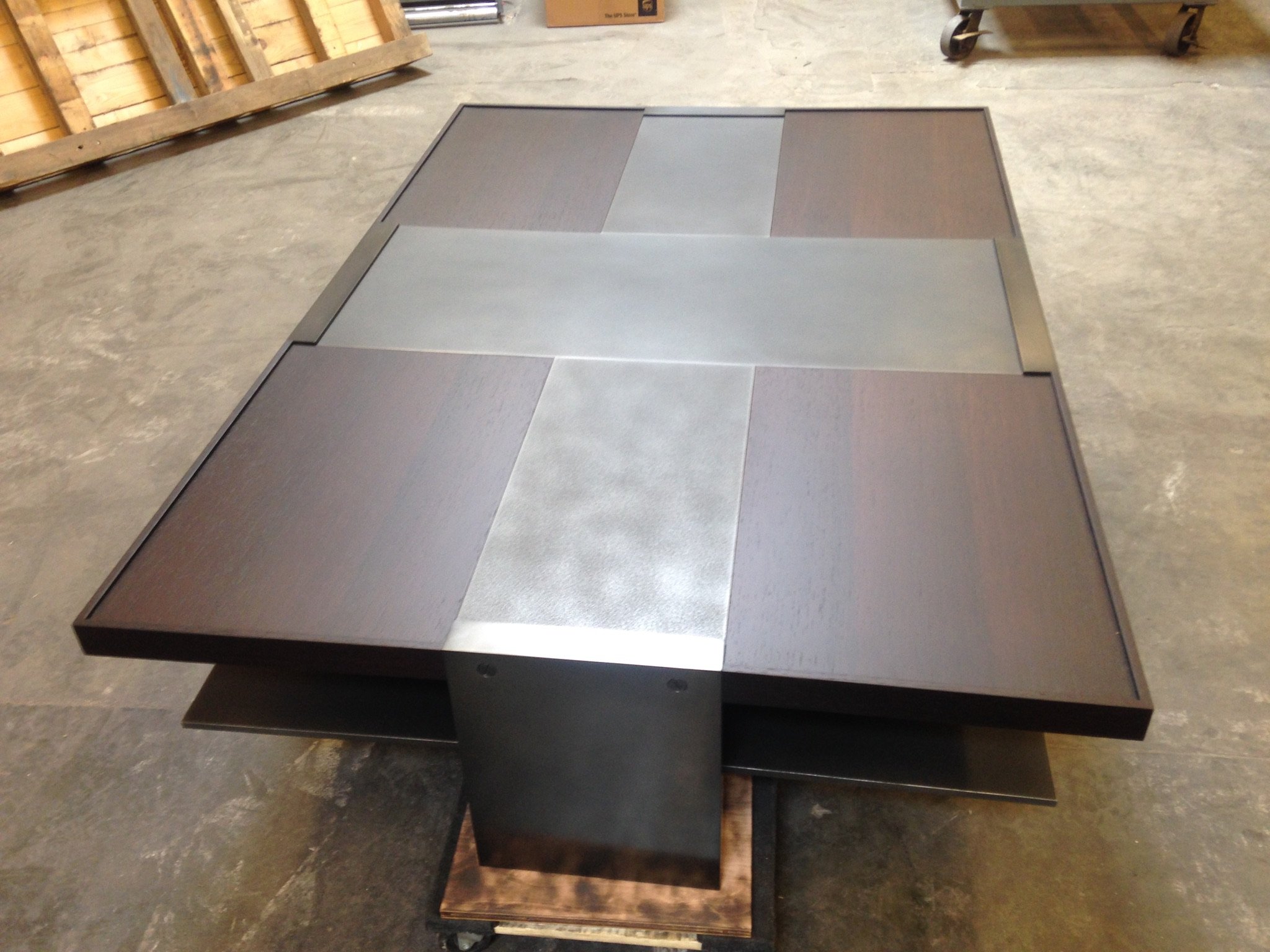 Coffee table with a geometric pattern of metal panels.