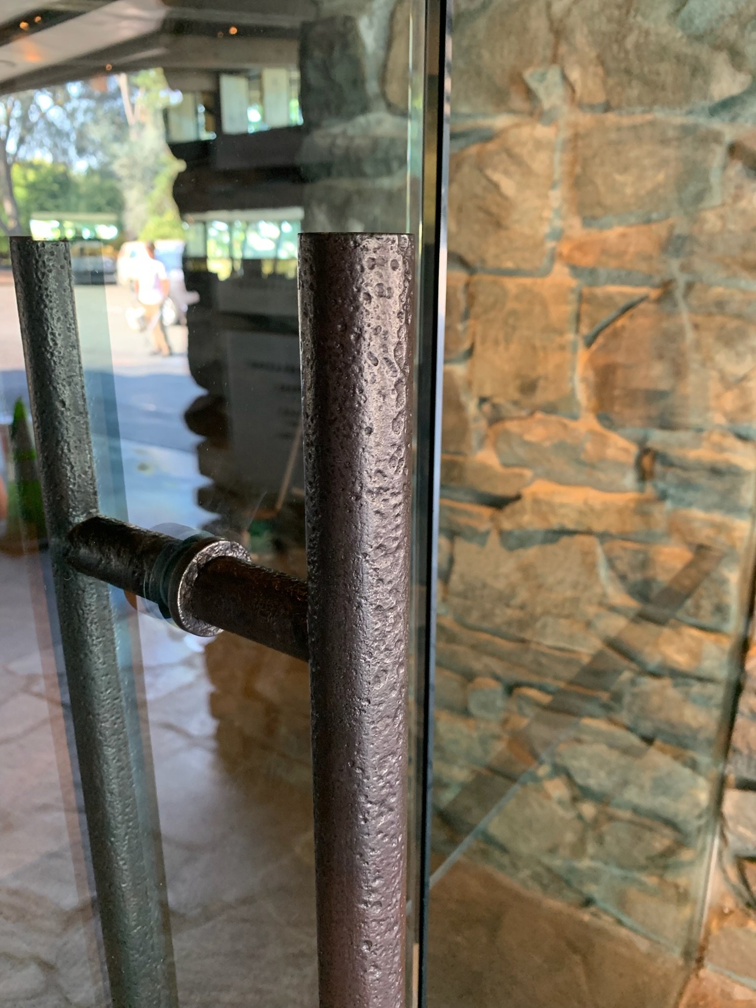 Close-up of a temporary metal door handle on a glass door at Canlis.
