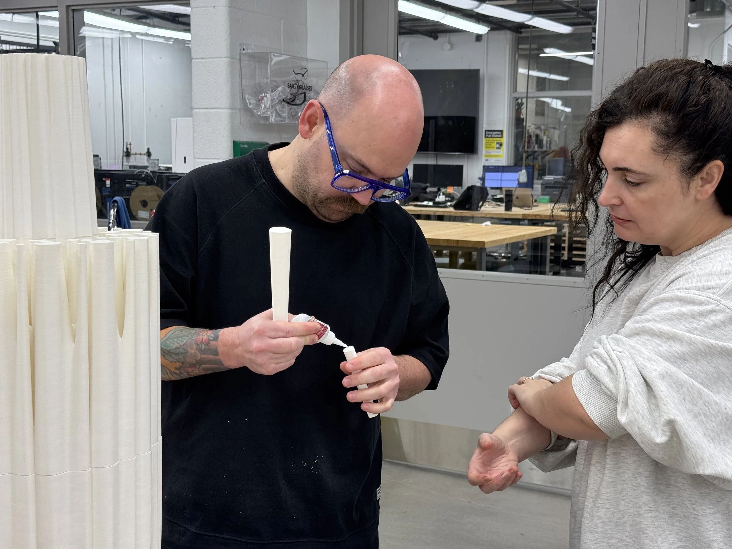 Process image showing team members gluing together 3D-printed pieces