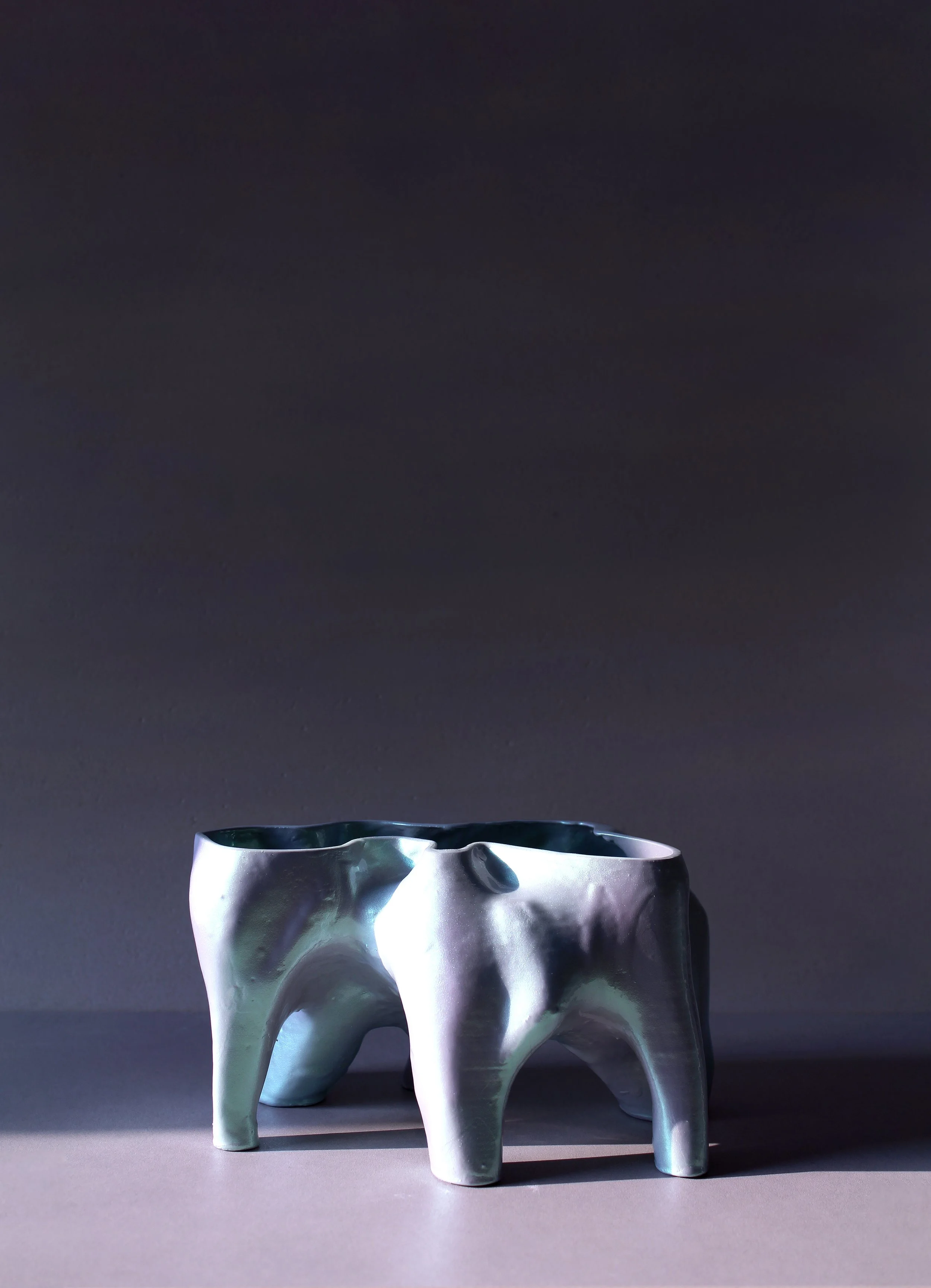 Quad-legged vessel with organic, folded contours and metallic glaze; part of Pet Objects 1’s sculptural domestic object exploration