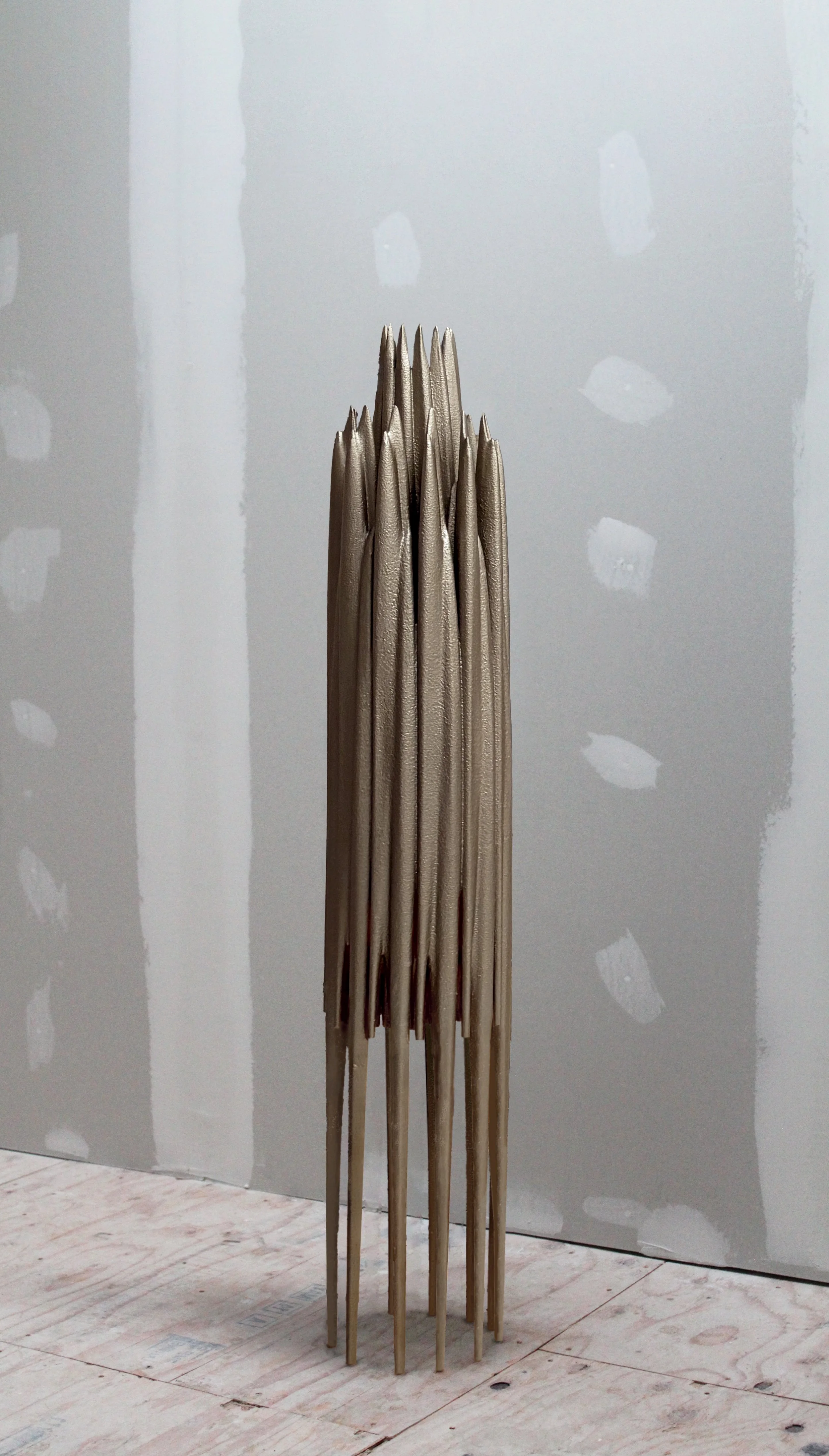 Floor lamp with organic form, and textured, metallic finish