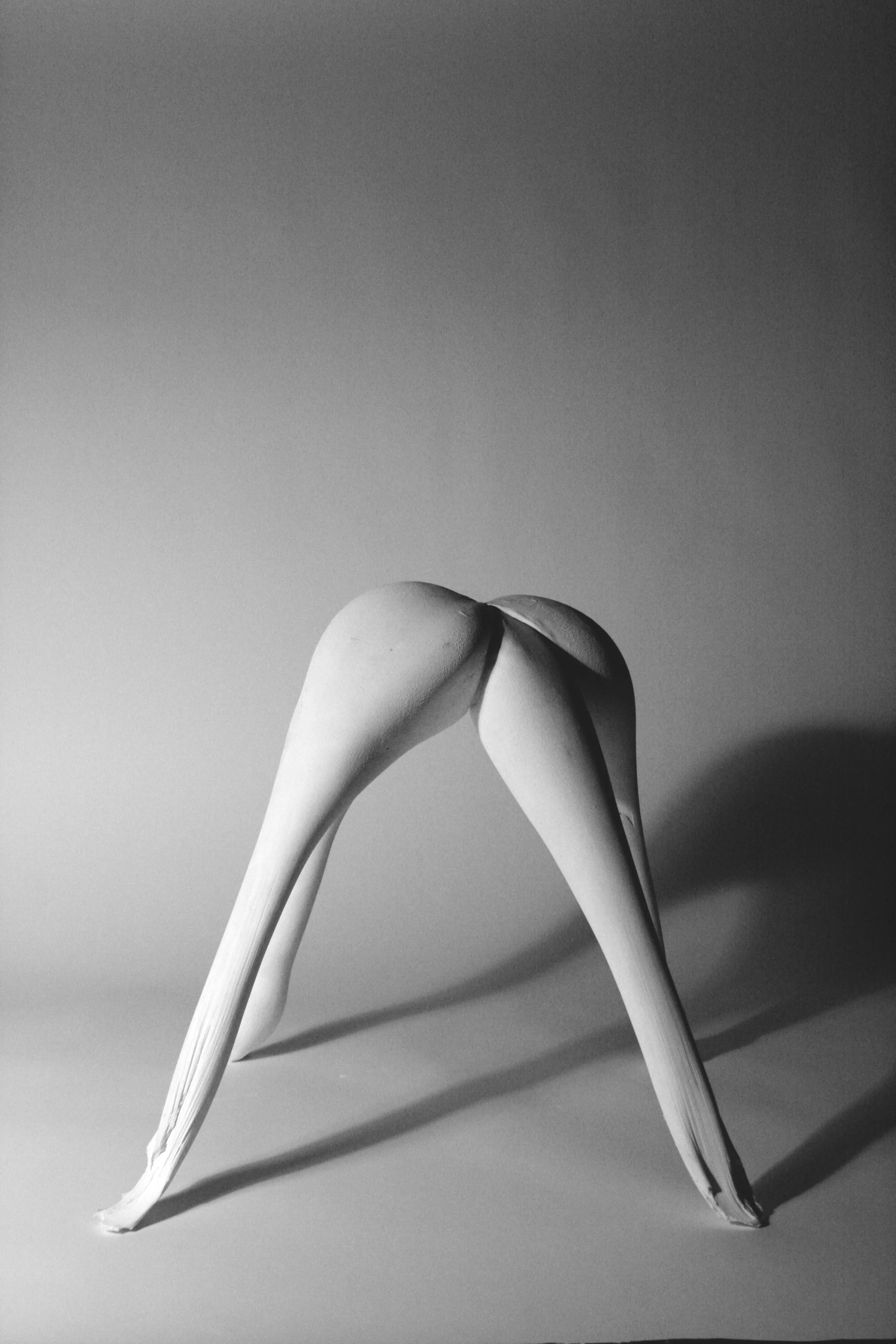 Expressive form with curves and thin legs cast in plaster using fabric formwork