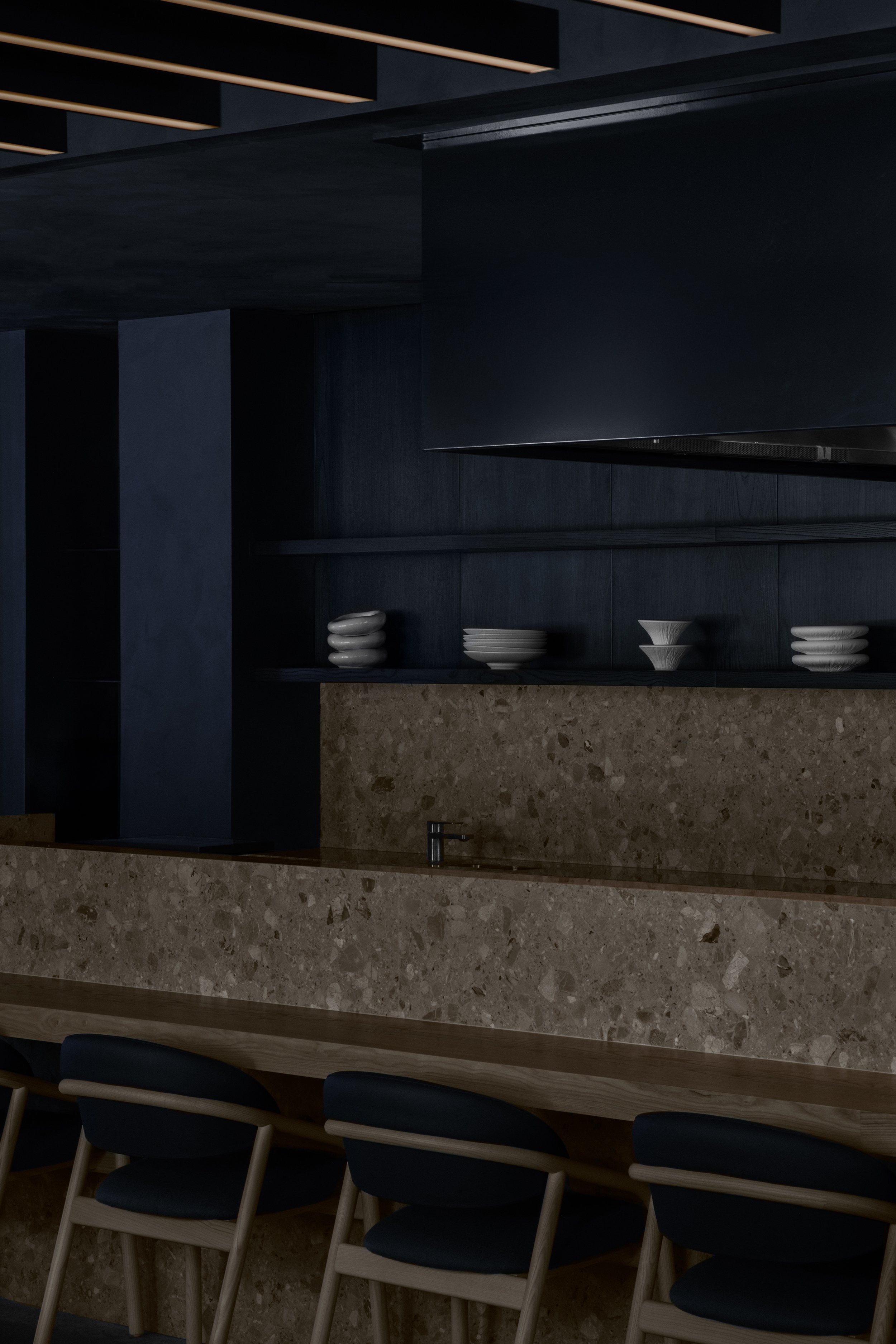 Main grill bar with stone backsplash and wood dining table
