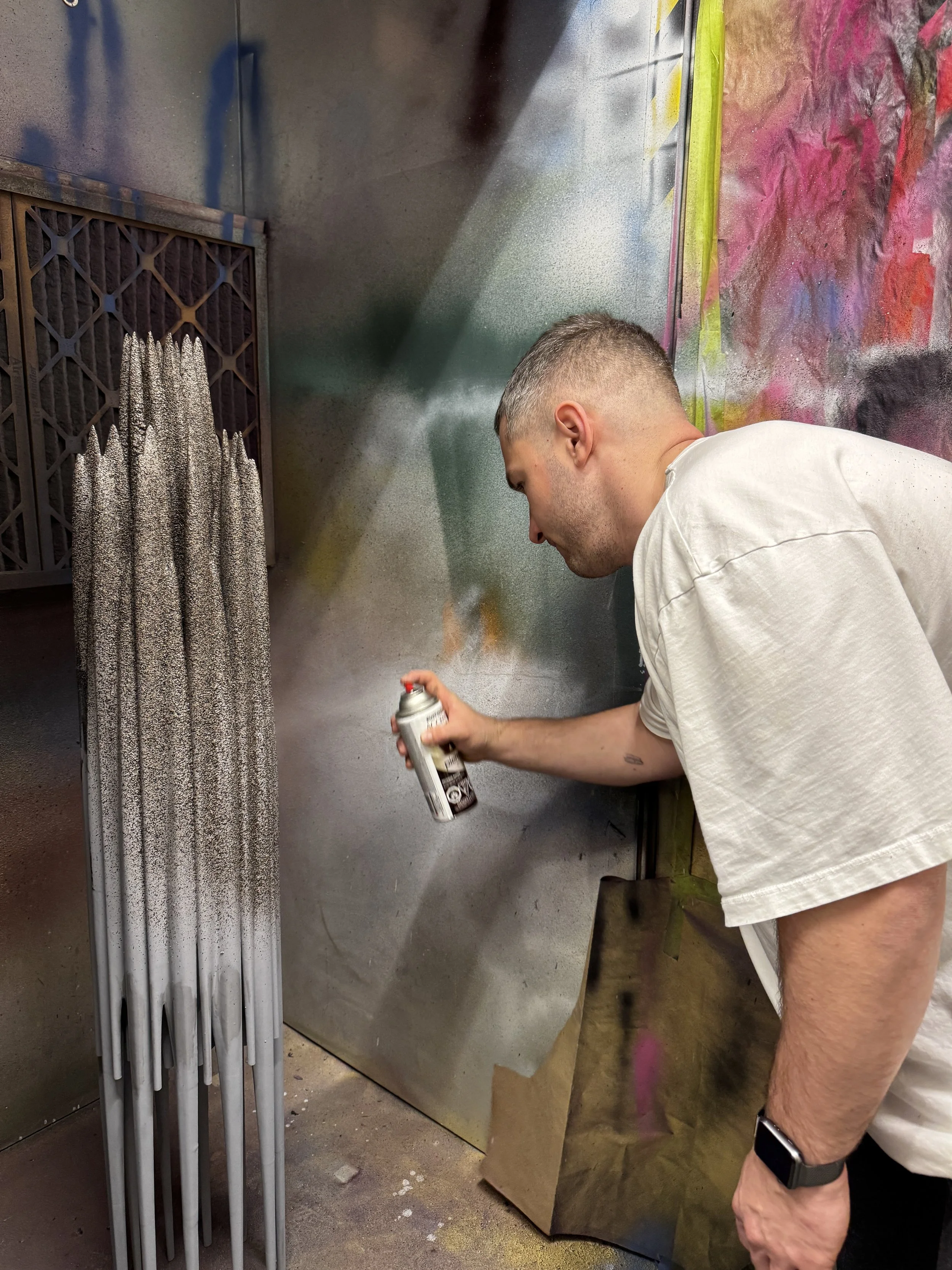 Pet Objects 2 process image of team member finishing the object with a textured spray paint