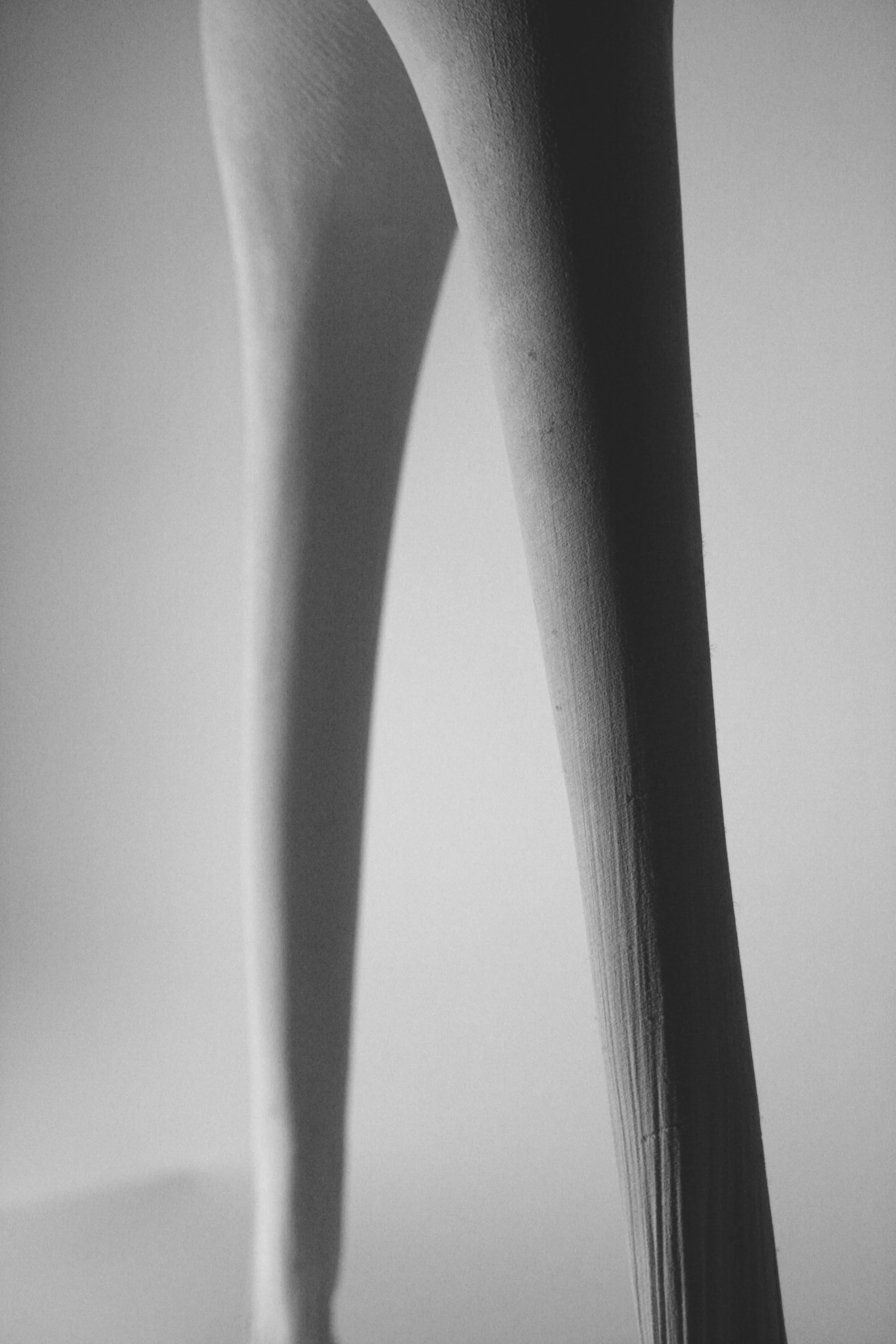 Detail image showing the curved form and surface texture revealing the fabric formwork used for casting