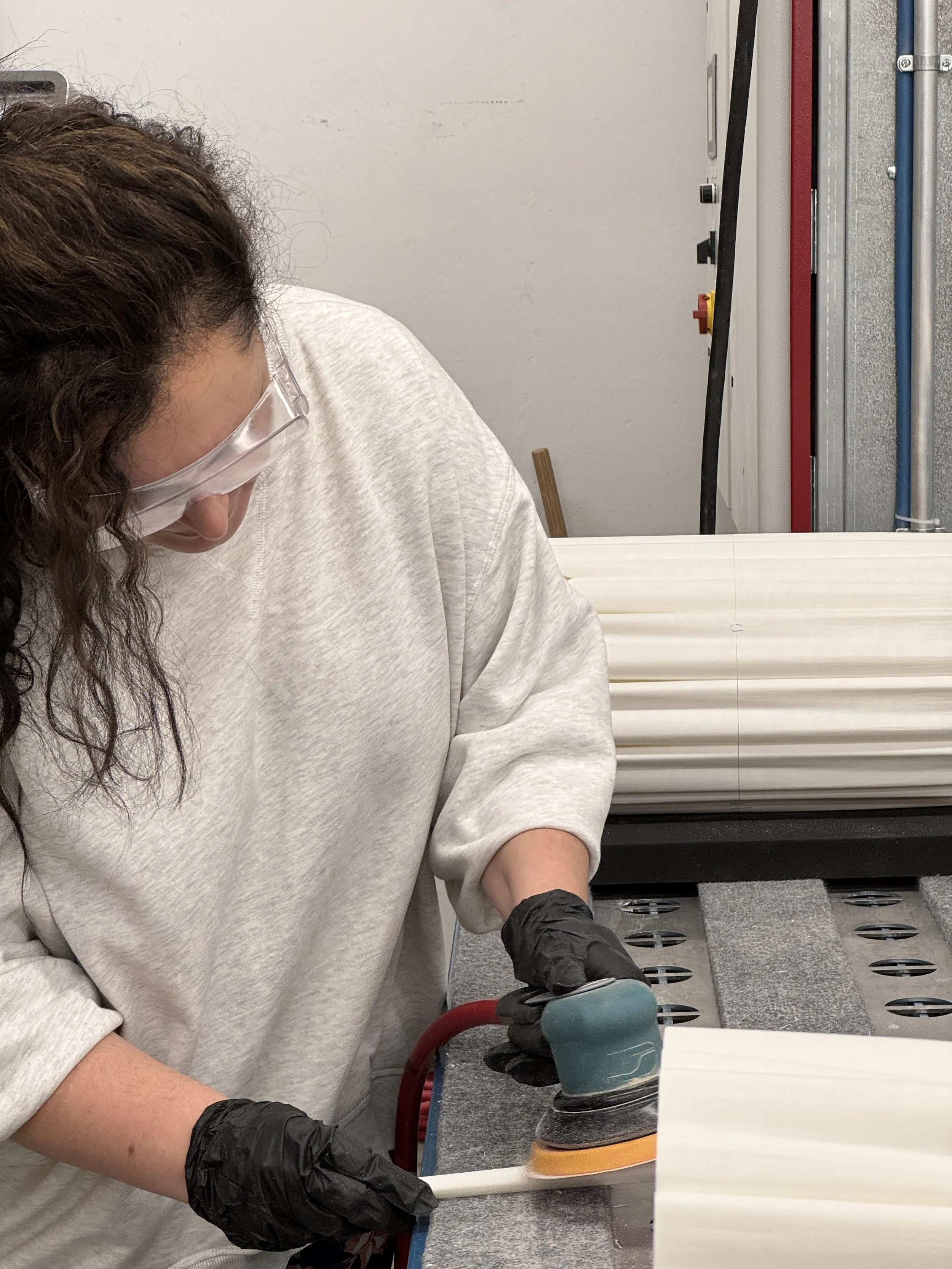 Process image of team member sanding joints smooth prior to finishing