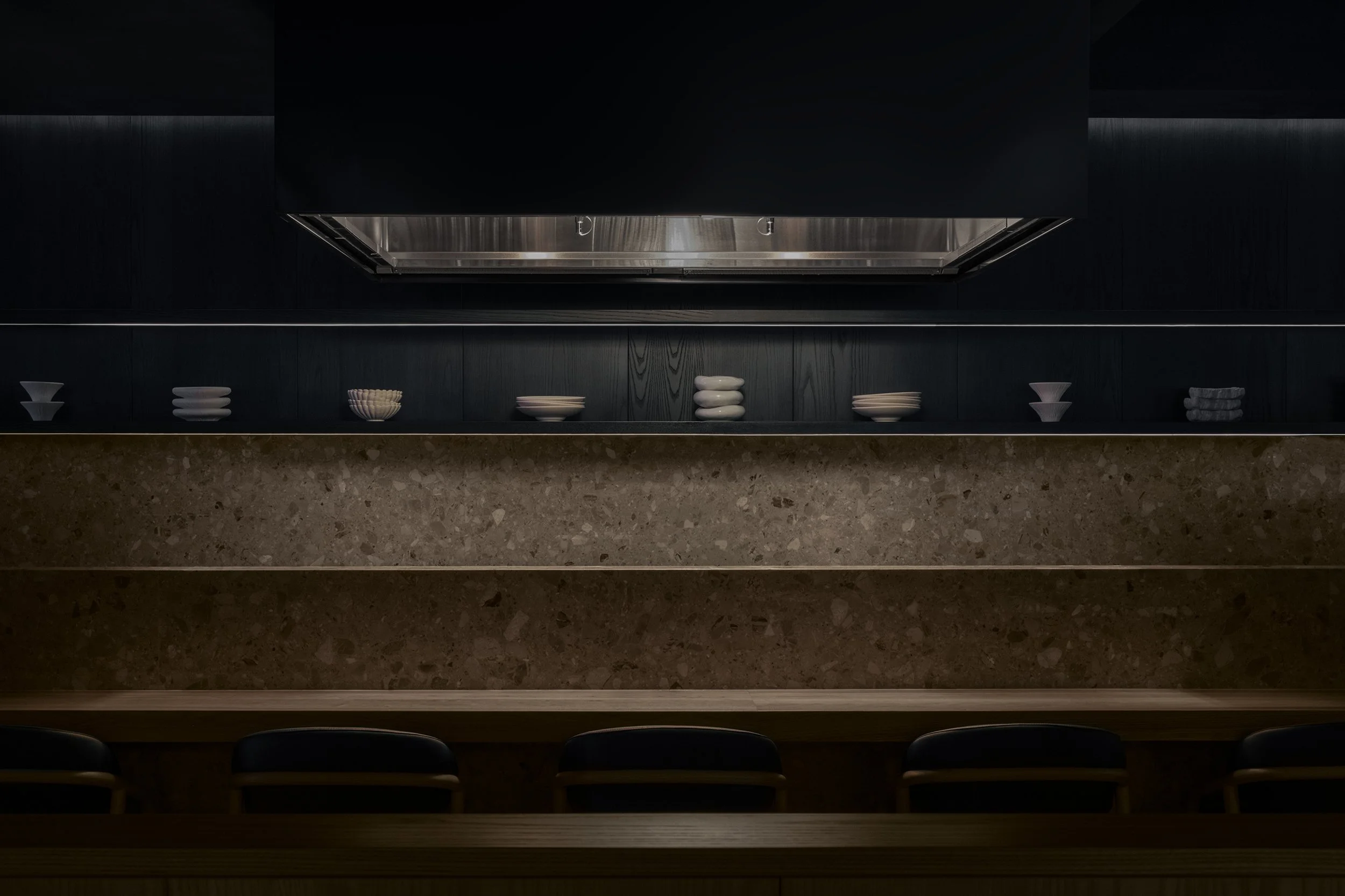 Japanese wagyu grill with stone backsplash and blue-stained wood shelving