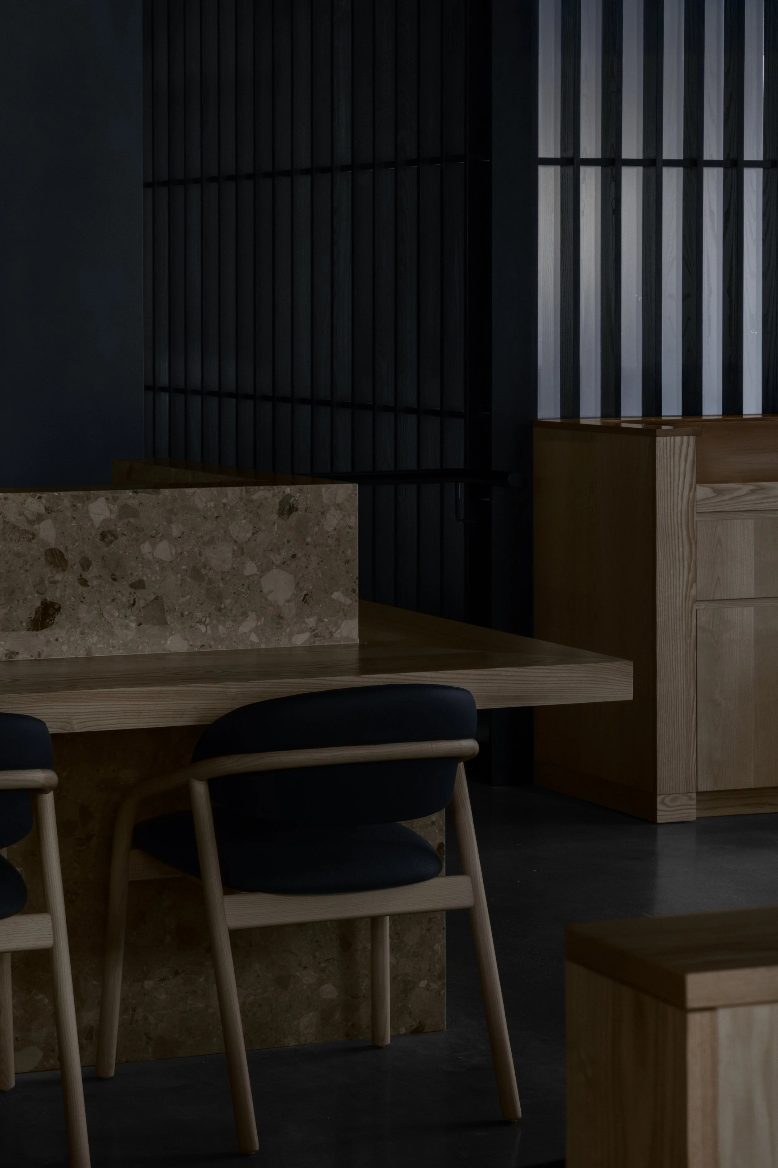 Main grill bar with stone backsplash and wood dining table
