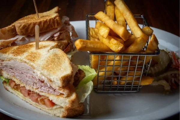 Club sandwich with fries on a plate