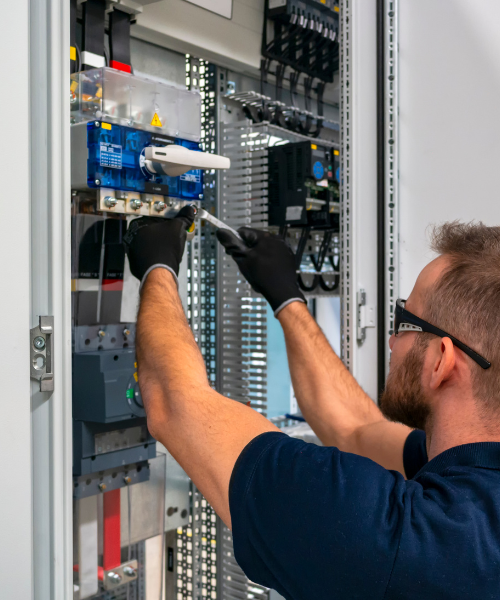 Man working on a circuit breaker