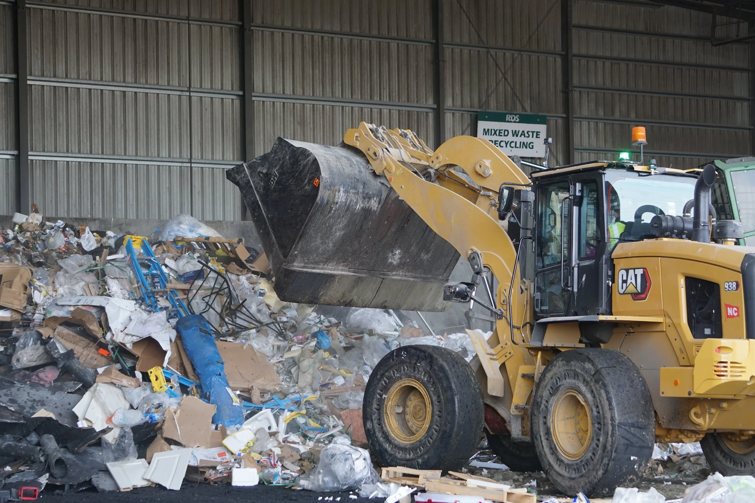  An excavator pushes debris into the tipping flood building at Recycling &amp; Disposal Services in Ferndale, Wash., on Feb. 6, 2026. The RDS site had many excavators and front loaders on hand to accumulate and manage the materials being brought in. 