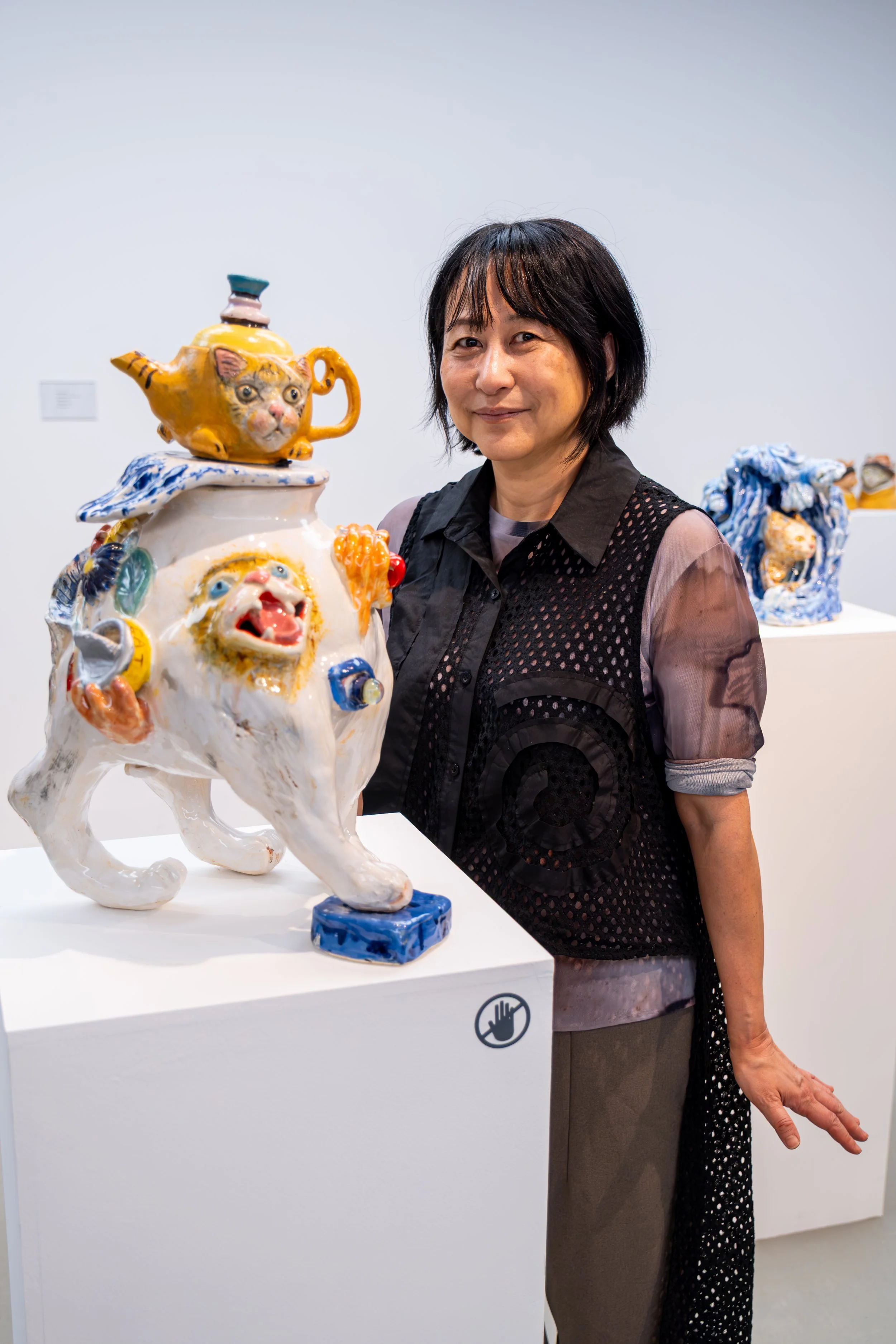 North East artist photographed alongside ceramic artwork at the National Glass Centre.