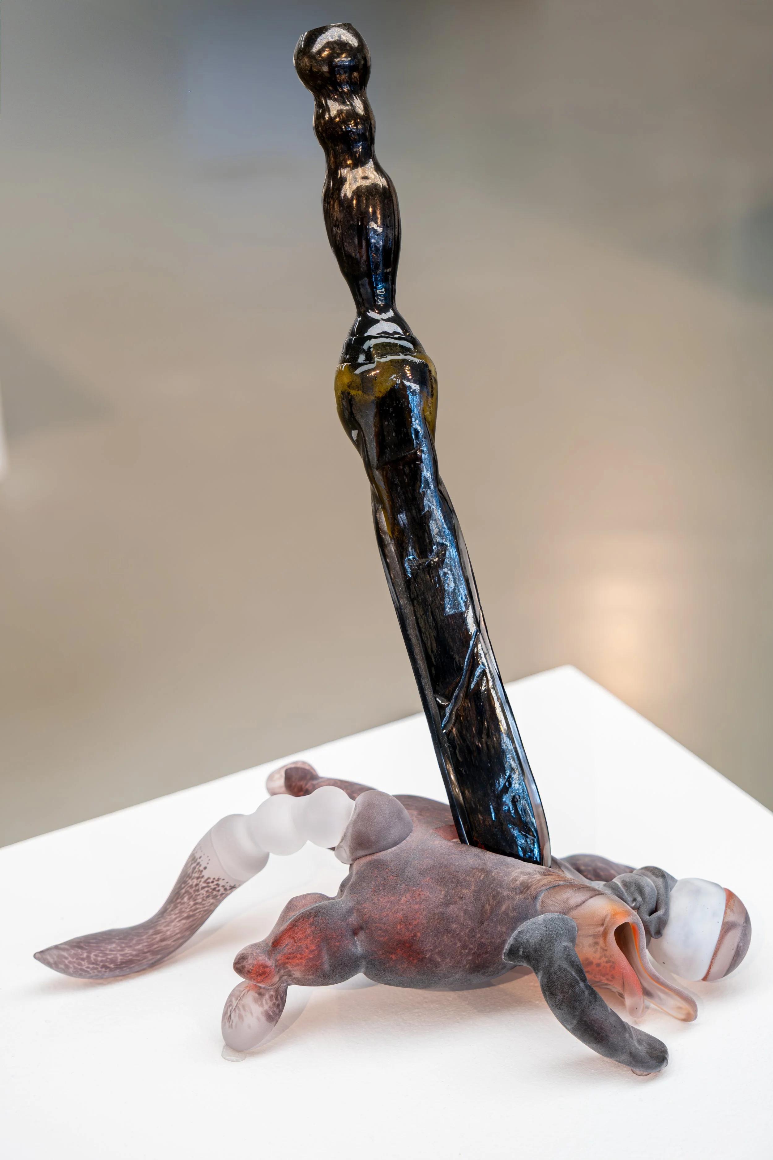 Ceramic artist photographed alongside their exhibition artwork at the National Glass Centre.