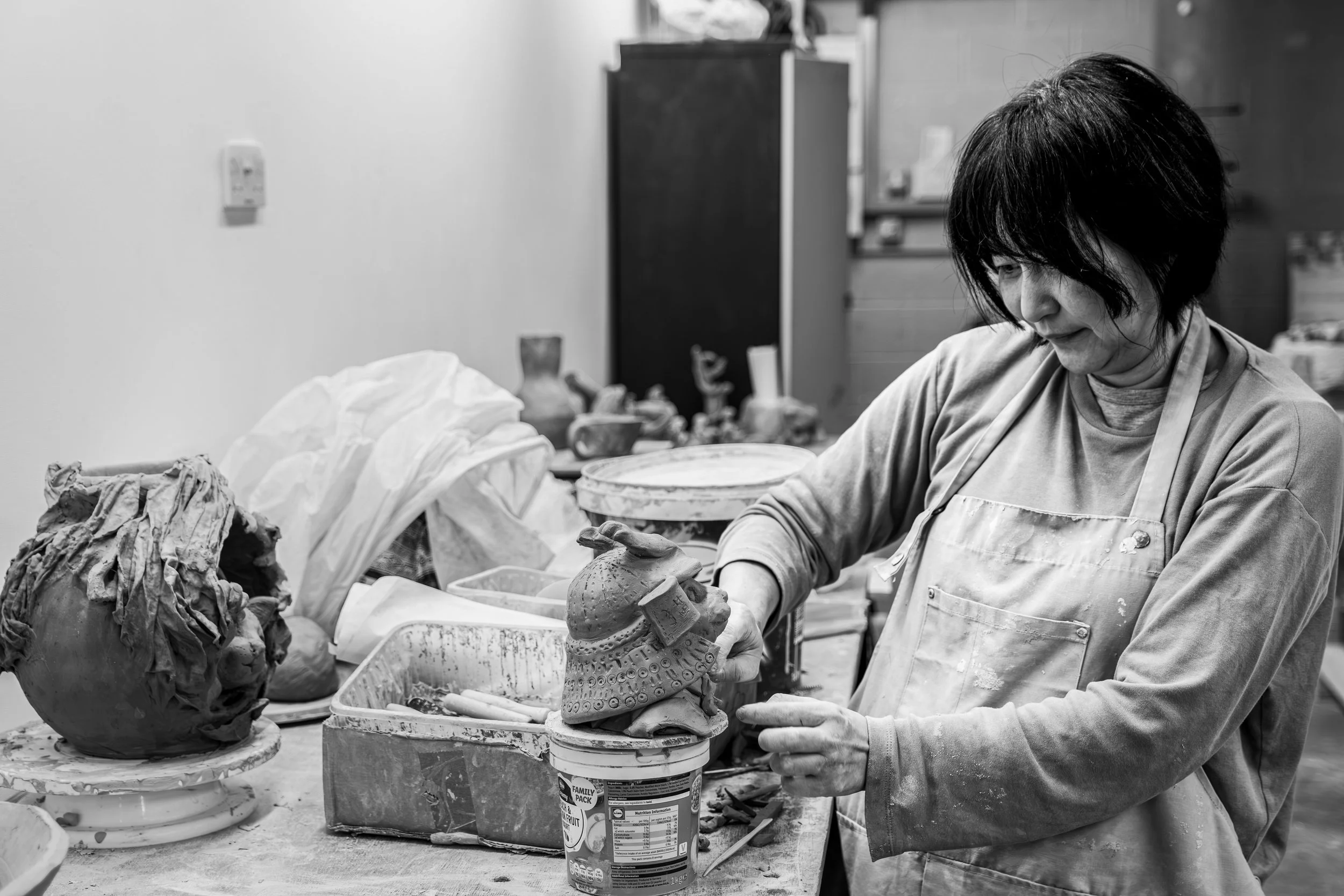 Shaping clay as the National Glass Centre, a student being creative