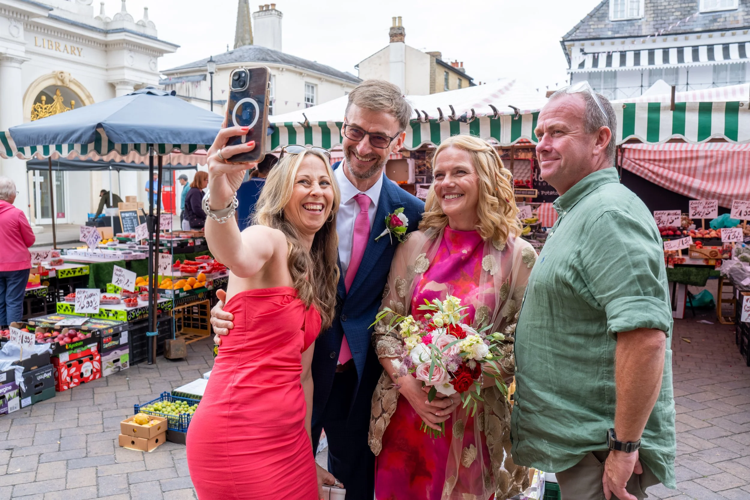 Newly married couple photographed in a market square on their wedding day in North East England.