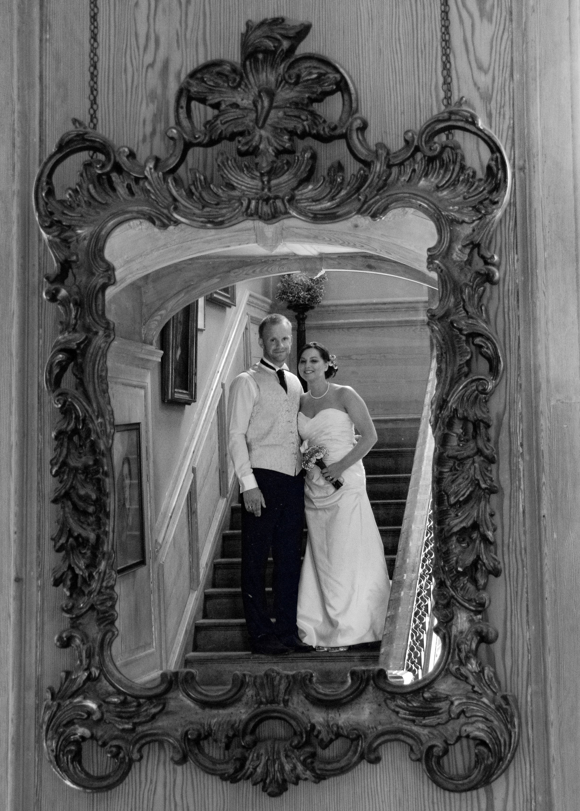 Bride and groom photographed in a mirror reflection.
