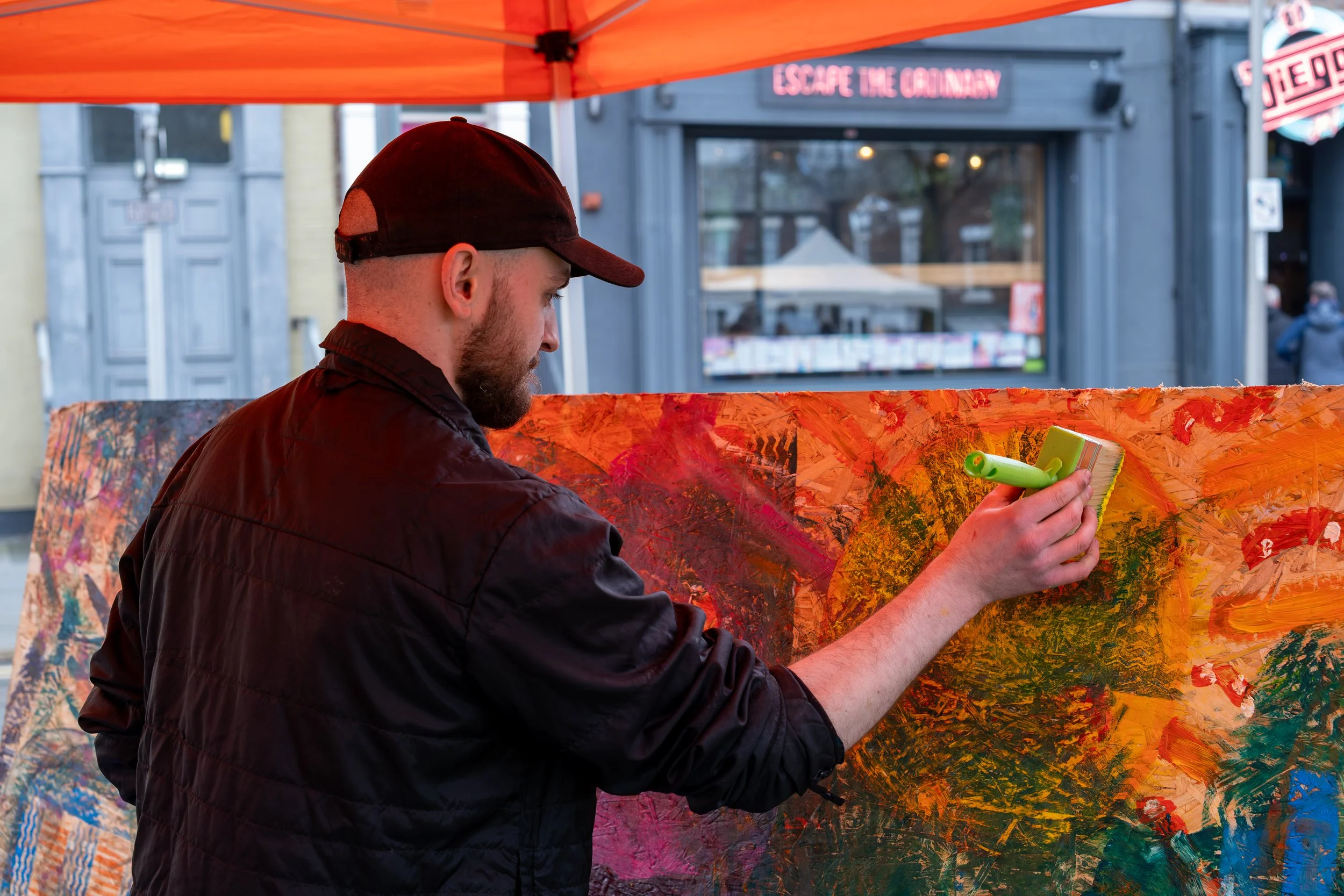 Artist painting on canvas at Sunniside in Sunderland – documentary photography of the local arts community.