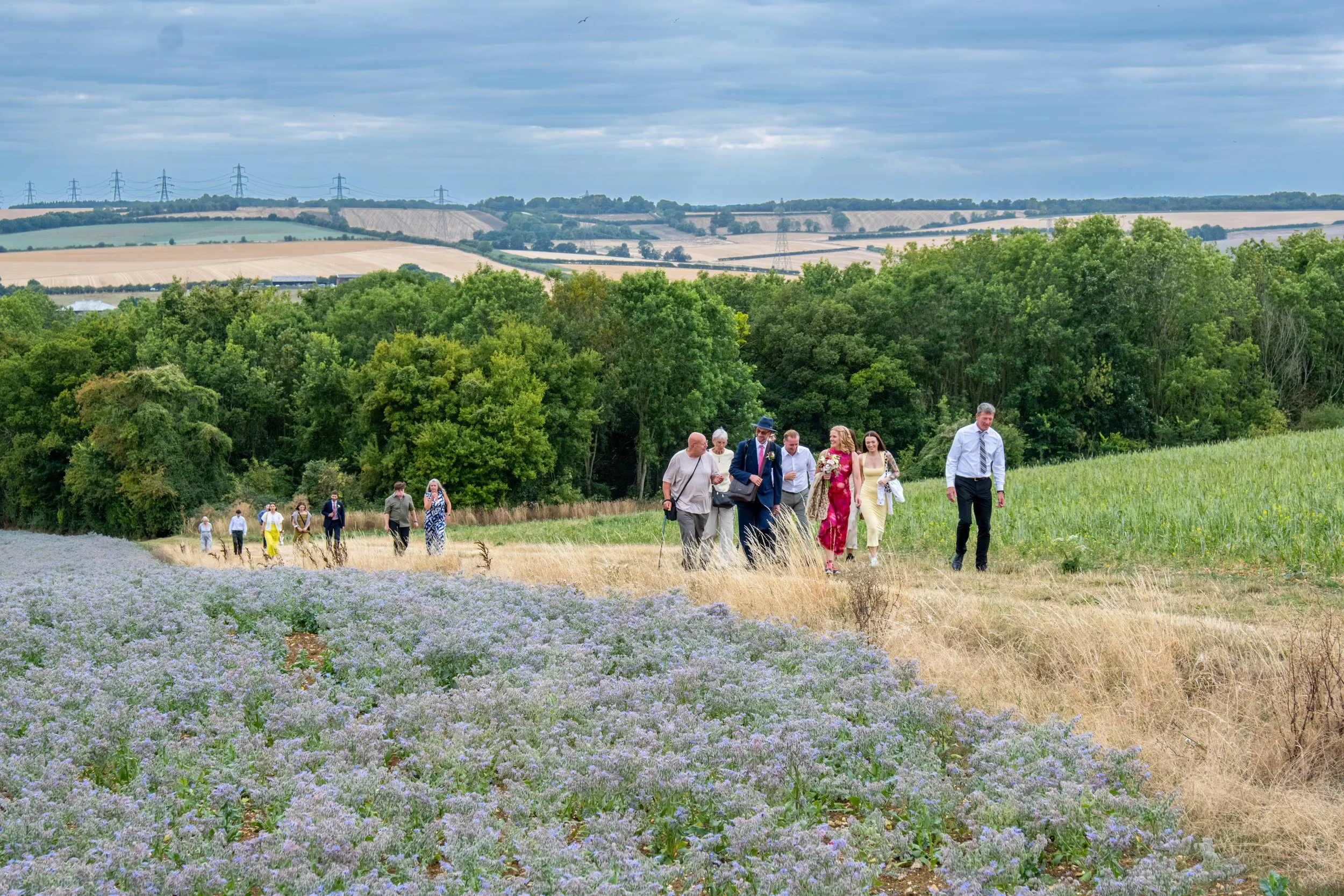 Bridal party photographed in a natural setting, walking in an outdoor location in the North East. 
