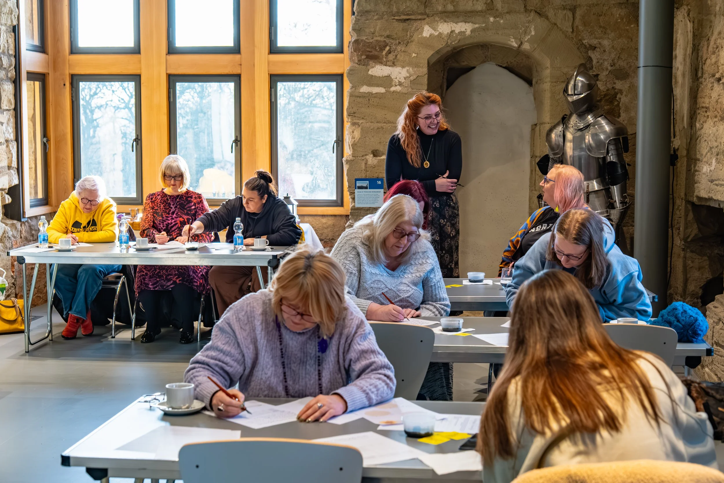 Creative workshop participant photographed at work during a calligraphy session at Hylton Castle.
