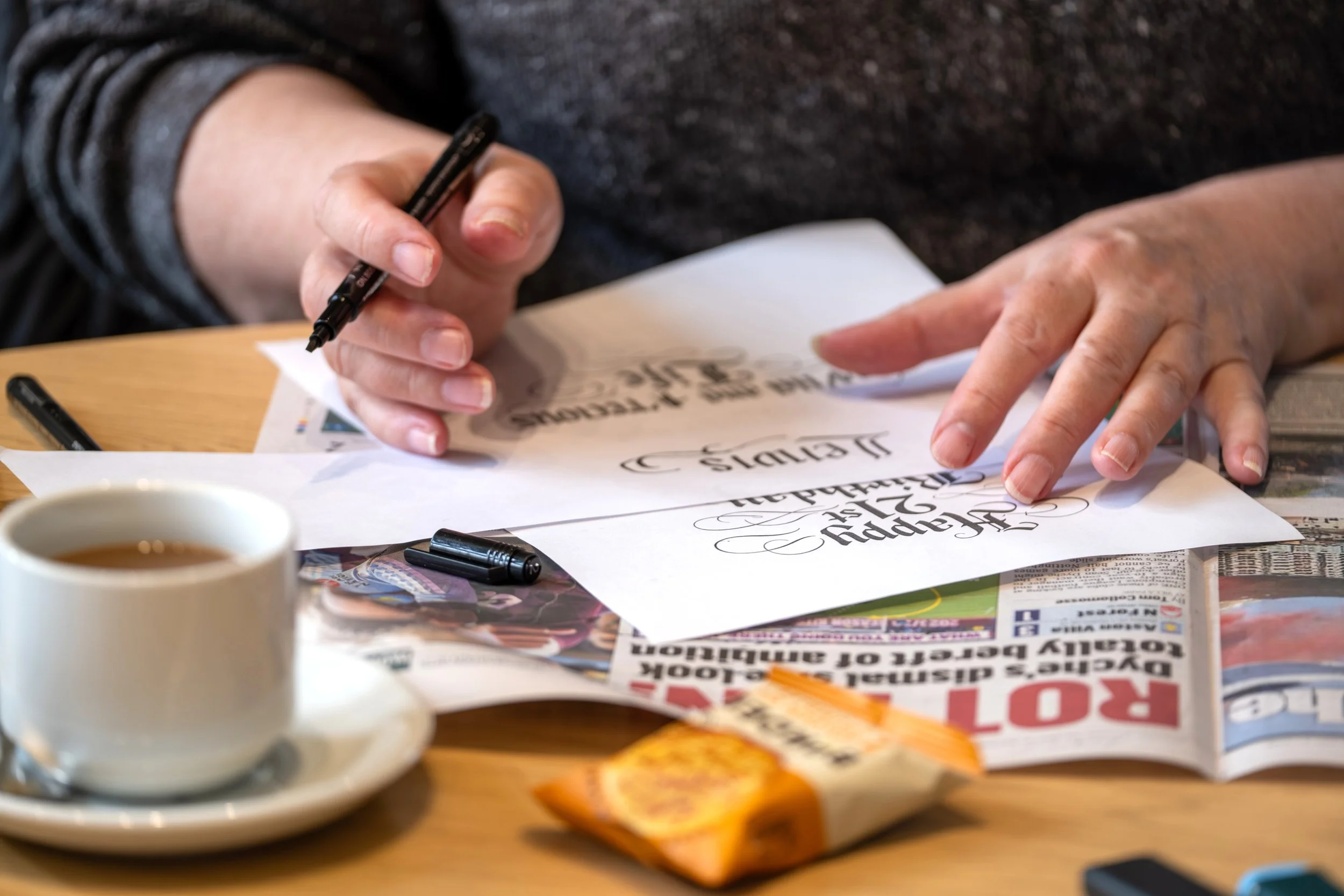Participant taking part in a creative calligraphy workshop at Hylton Castle in Sunderland.